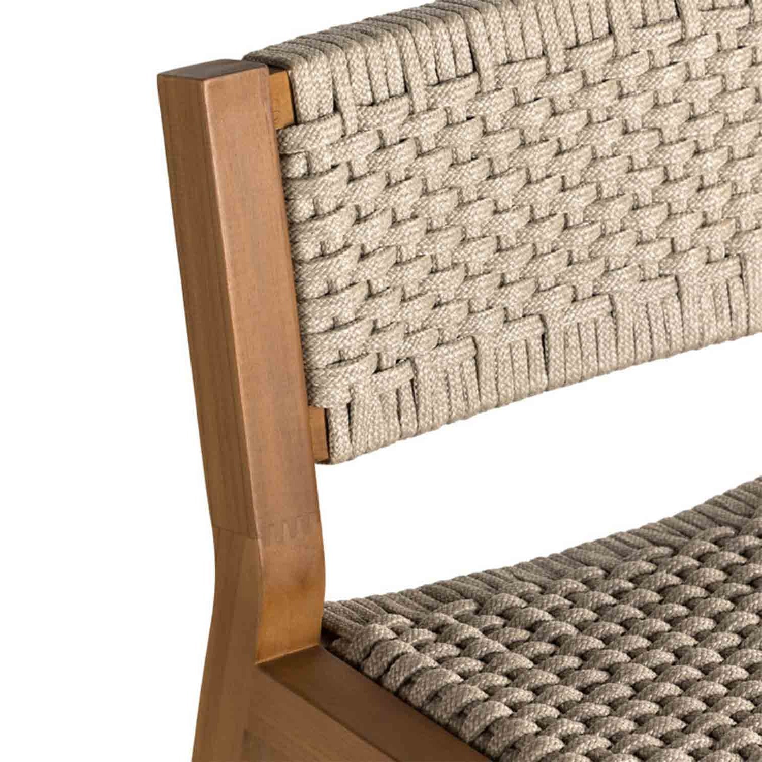 Close-up of an armless outdoor bar stool showing a natural teak frame with beige woven rope seat and back in a coastal style.