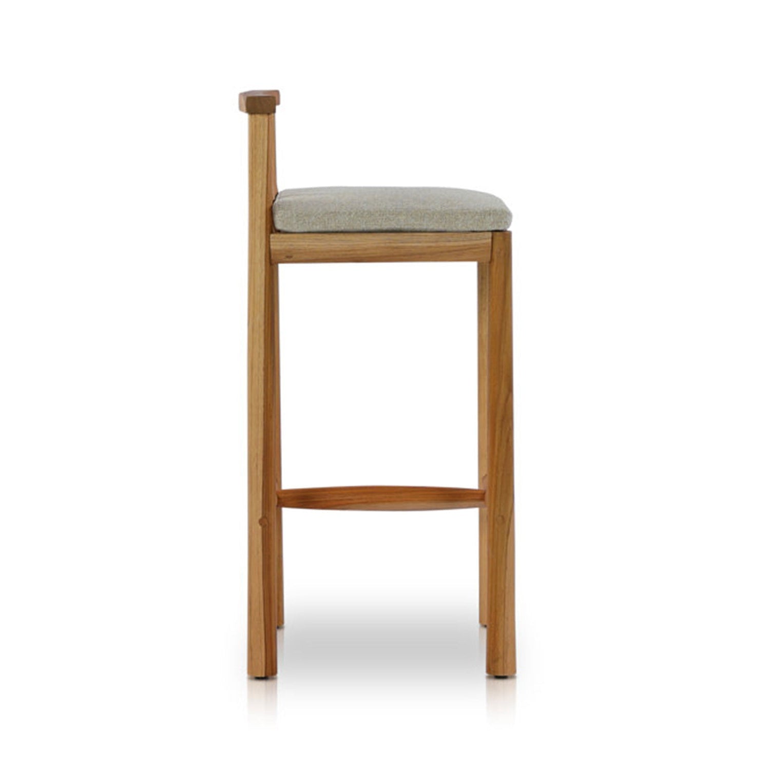 Armless teak outdoor bar stool with a light gray upholstered seat cushion, slim solid-teak frame, single low rear post and curved front footrest in a minimalist coastal-modern style on a white background.