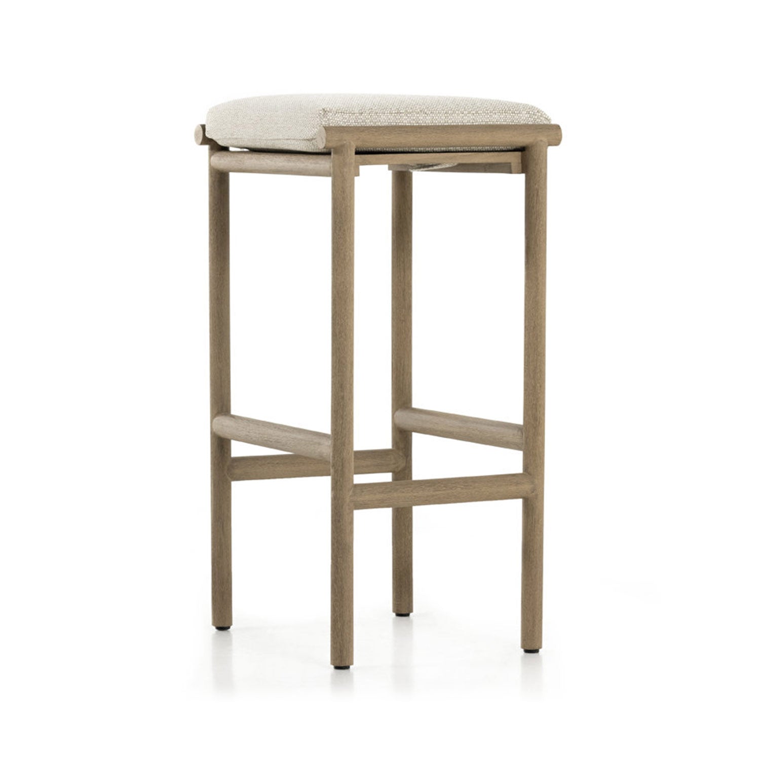 Backless outdoor bar stool with a light teak frame and beige upholstered seat, featuring slender round legs and intersecting crossbar footrests for a coastal-modern, minimalist look.
