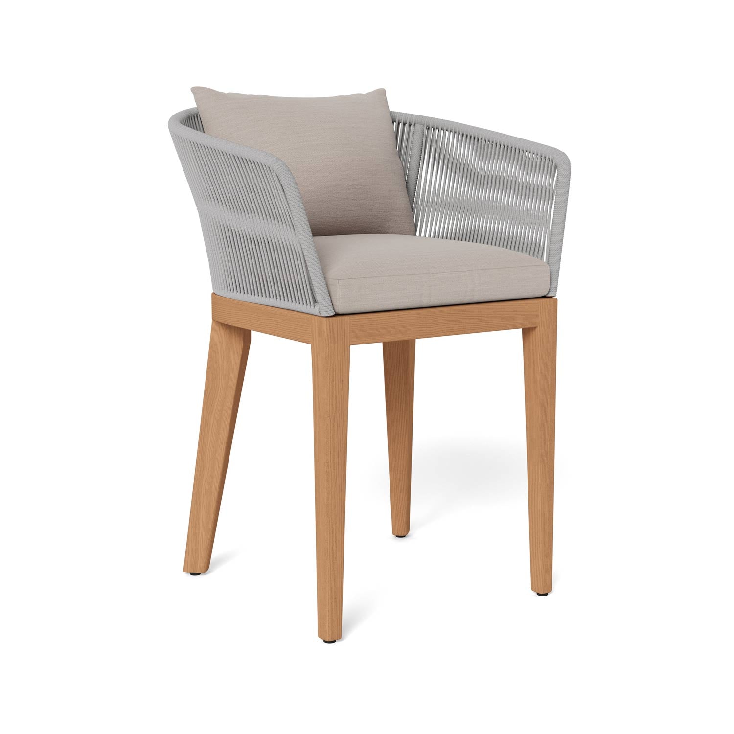 Outdoor bar stool with teak wood legs, light gray woven rope arms and back, and a beige upholstered seat cushion with matching throw pillow shown on a white background.