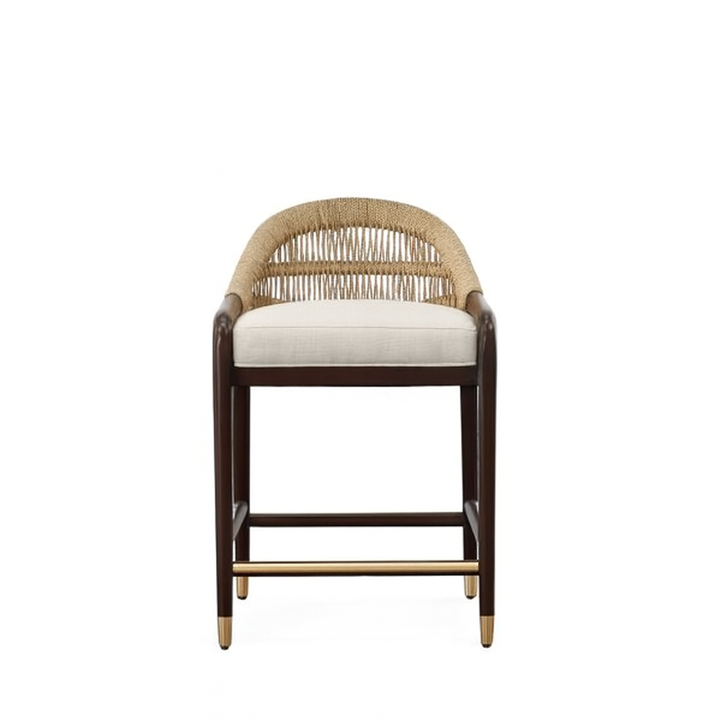 Front view of a teak-framed stool with woven rope back, beige upholstered seat cushion, dark teak legs and a brass footrest and leg caps.