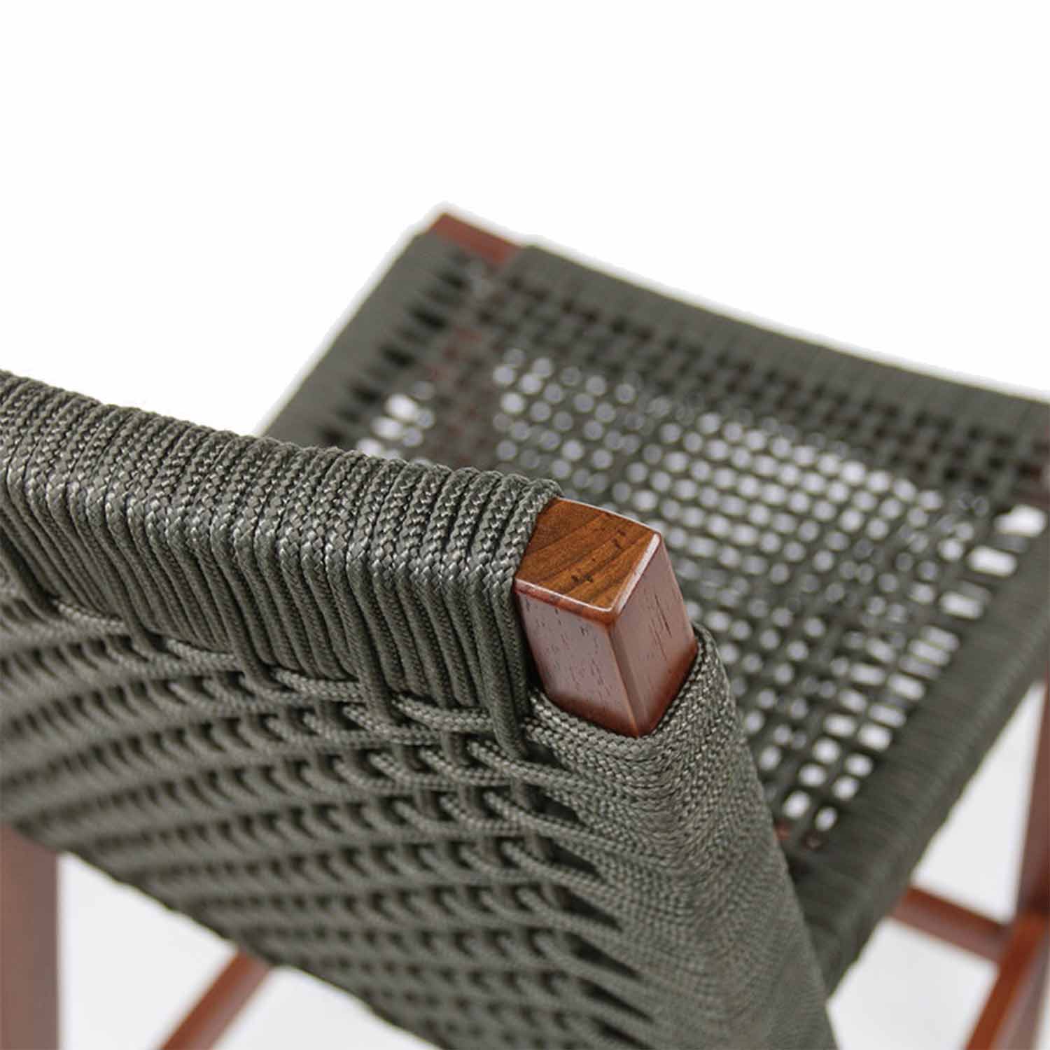 Close-up of an armless outdoor bar stool corner showing a square teak frame and tightly wrapped gray-green outdoor rope in a woven seat and back pattern.