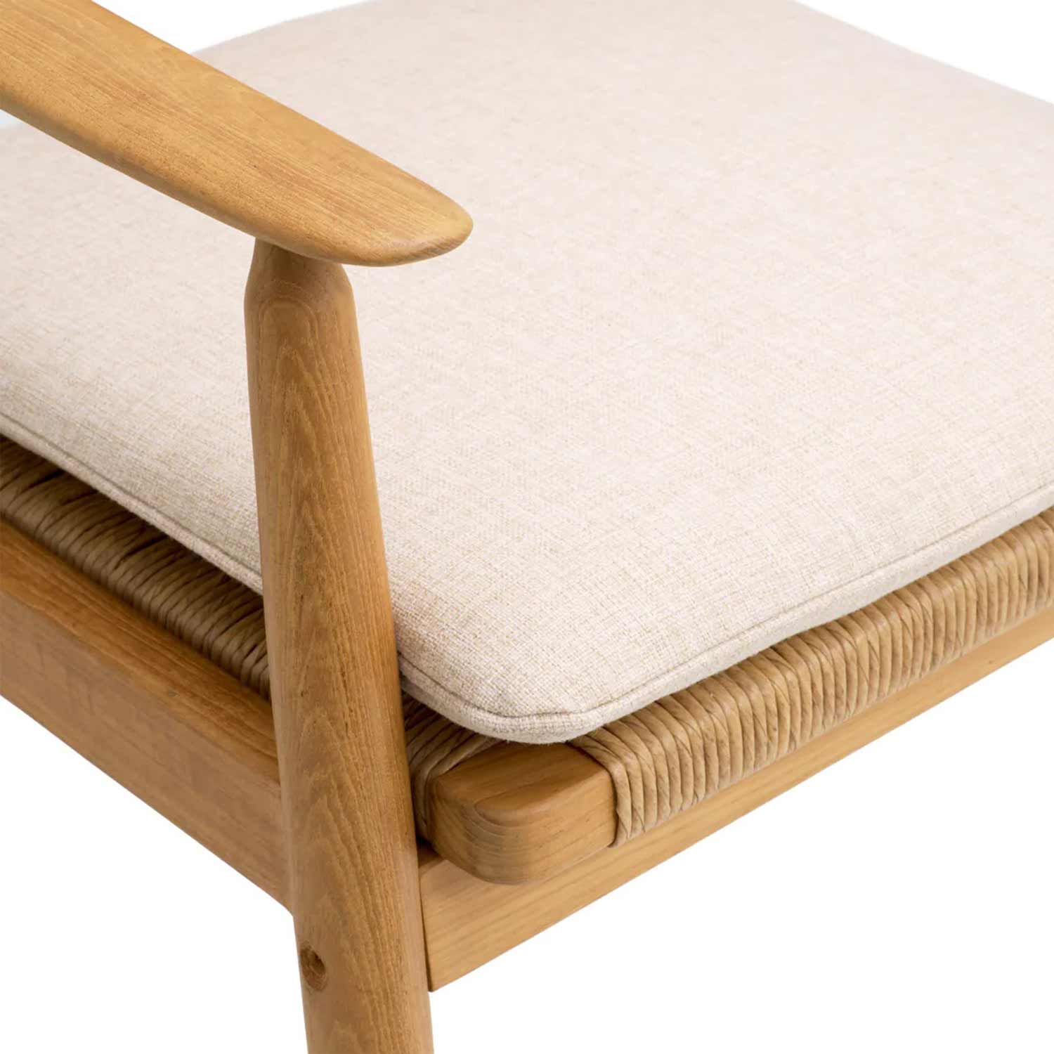Close-up of a natural teak armrest and leg with a light beige upholstered cushion sitting on a woven rope seat and teak frame.