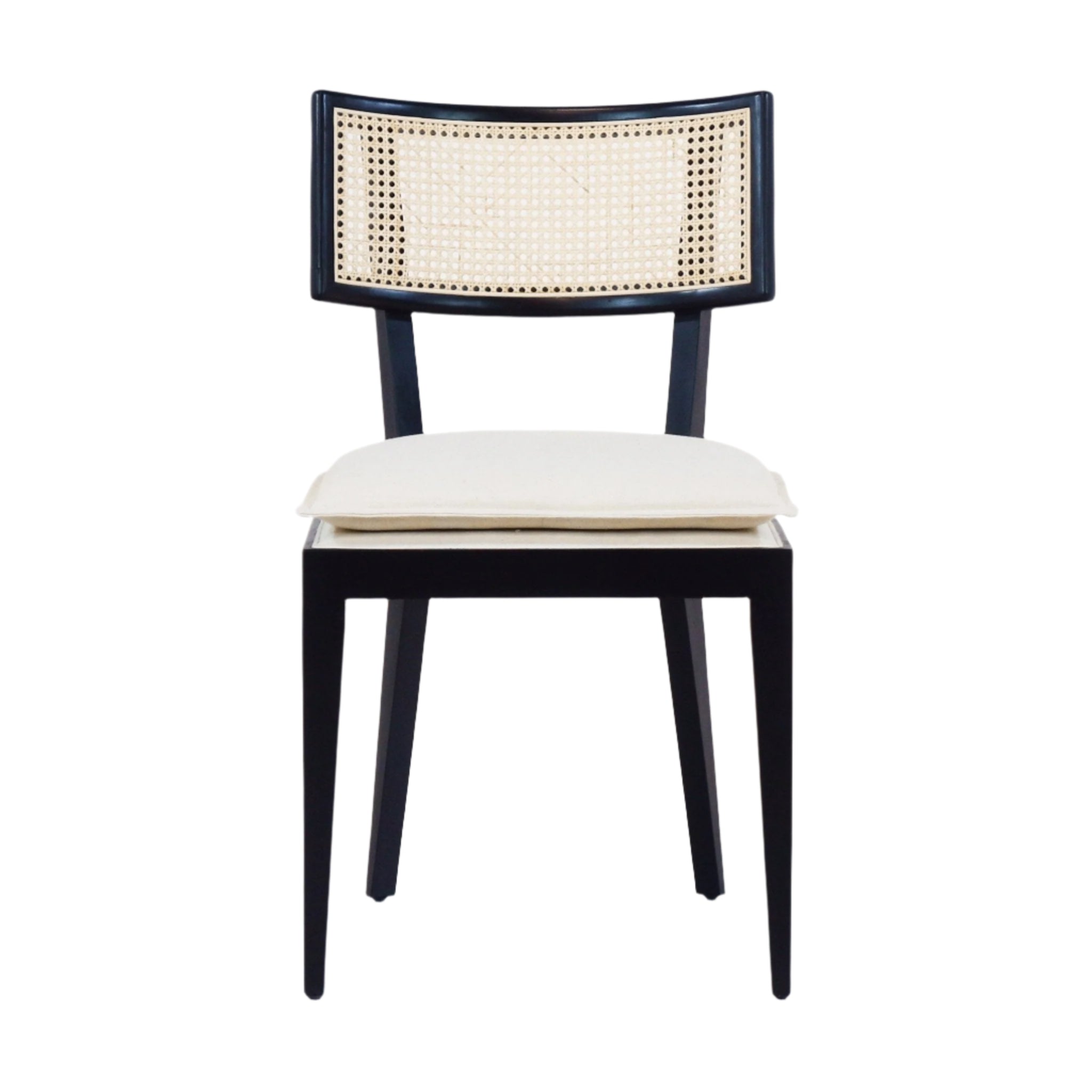 Front view of an armless black solid wood dining chair with a natural rattan cane backrest and a cream upholstered seat cushion, mid-century boho style, on a white background.