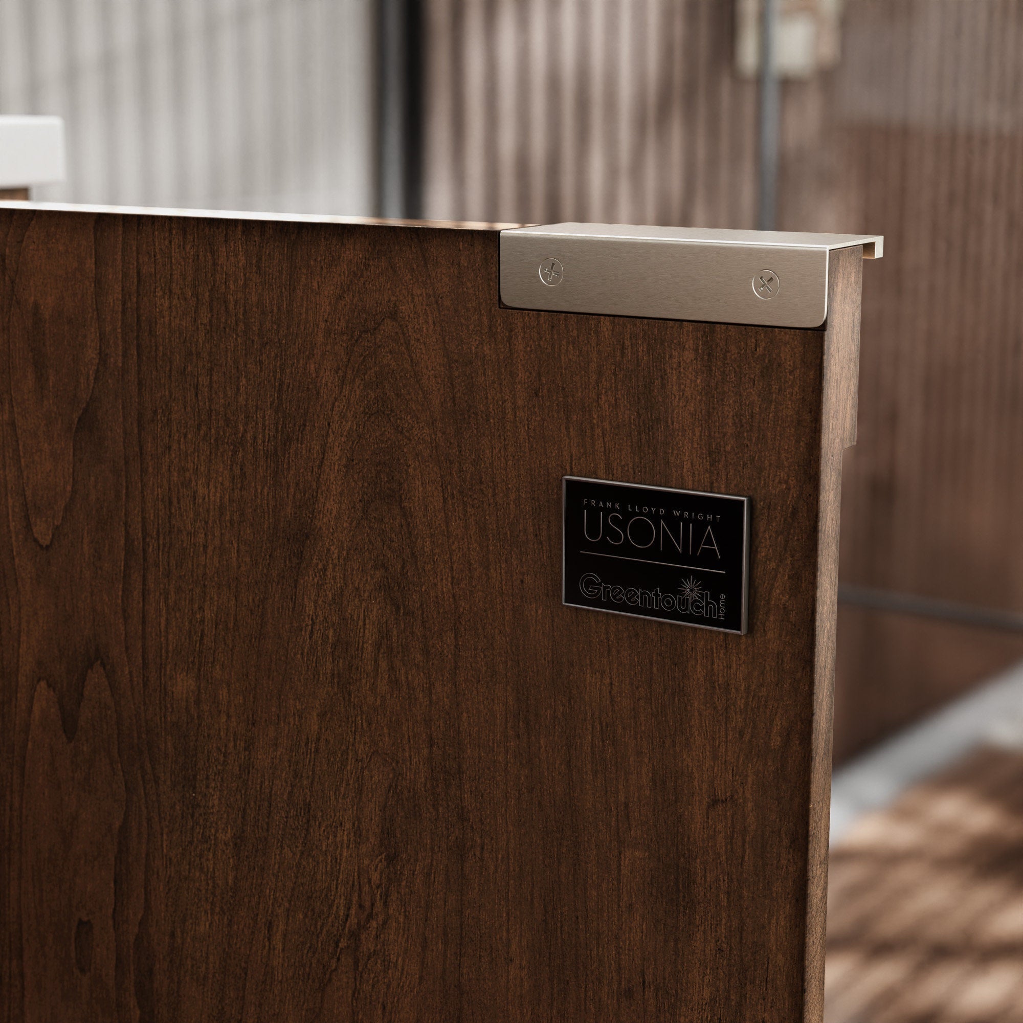 Close-up of a dark natural solid wood bathroom vanity panel showing a stone-colored top edge, brushed metal corner bracket with visible screws and a small rectangular badge, highlighting wood grain and modern details.