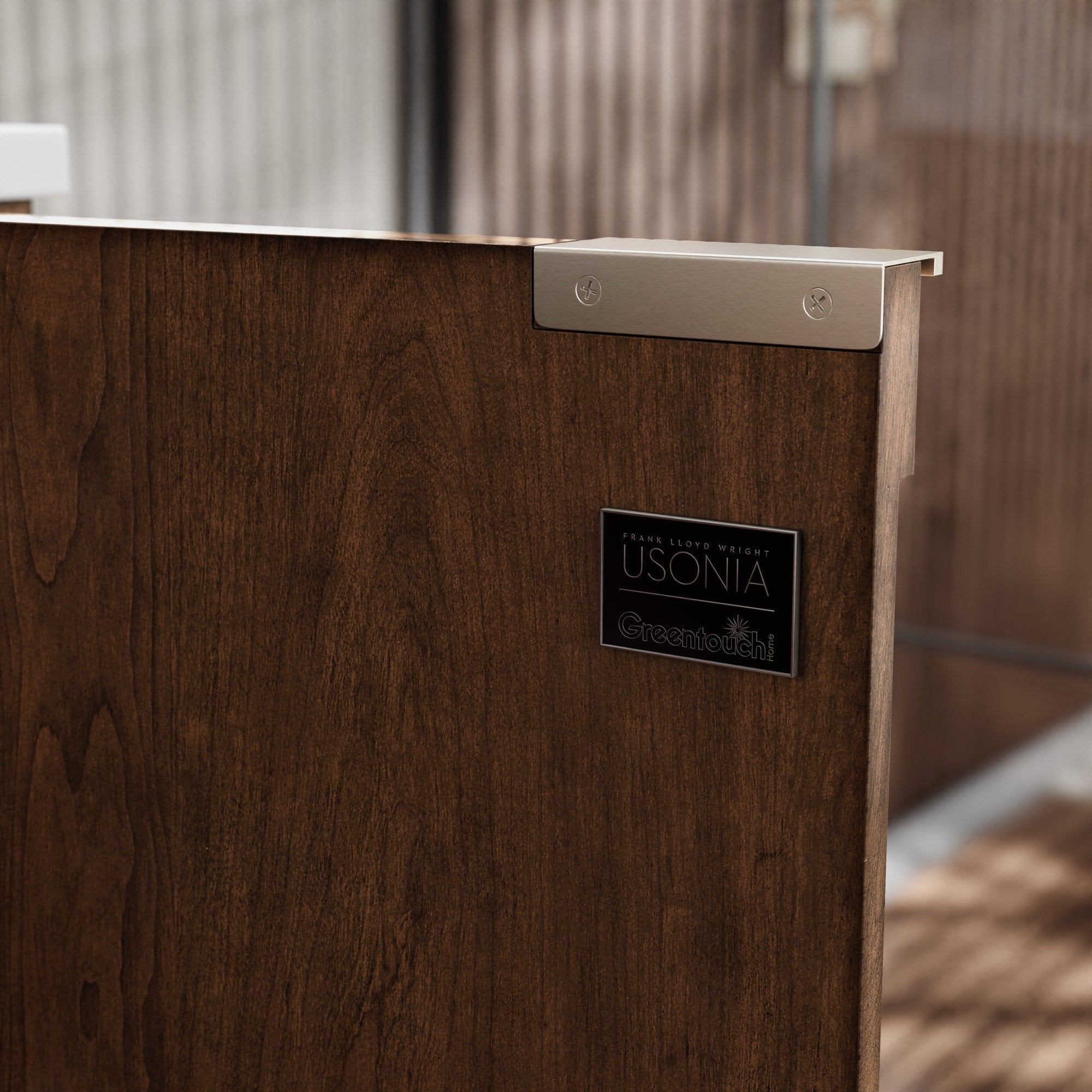 Close-up of a modern solid wood bathroom vanity side in warm brown with visible wood grain, a stone-colored top edge, brushed-metal corner bracket and a small rectangular badge on the cabinet face.