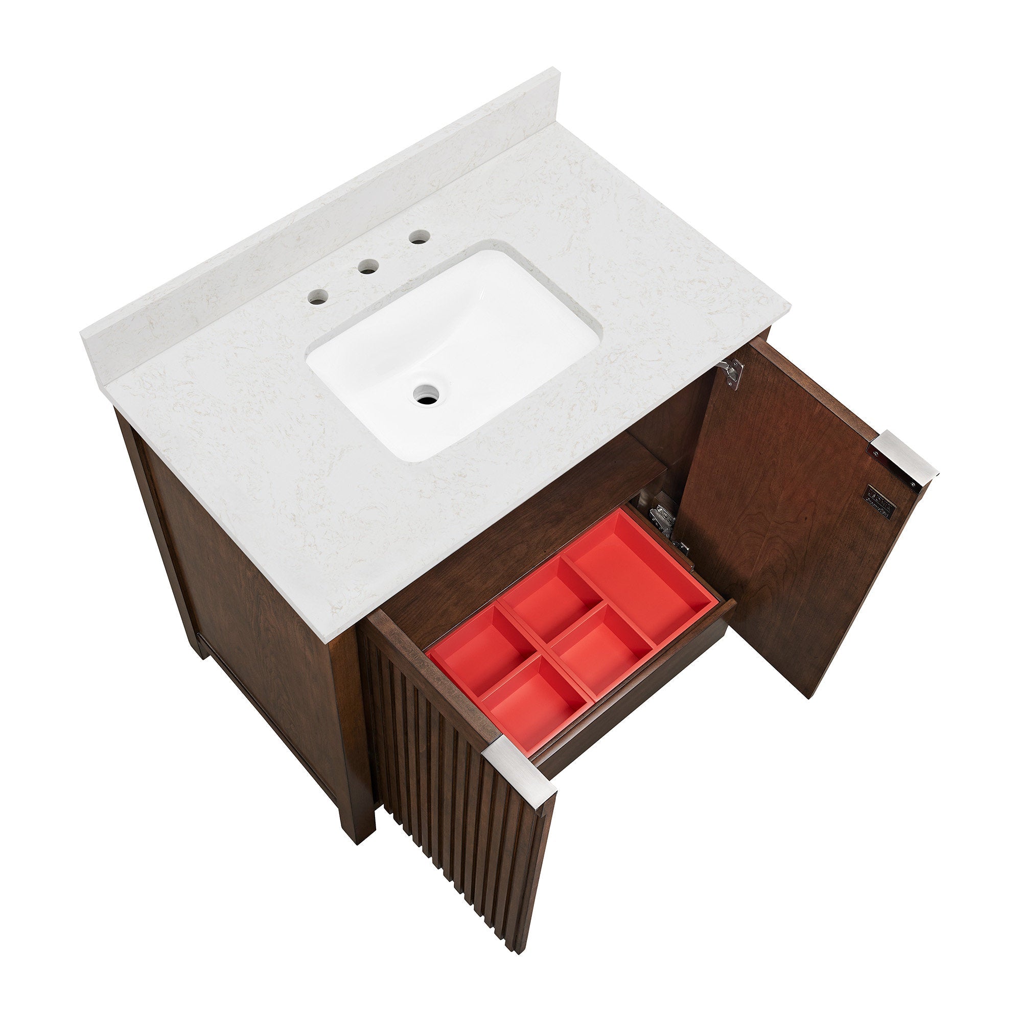 Top-down view of a modern solid-wood bathroom vanity with a stone-colored countertop and rectangular undermount ceramic sink; fluted wood doors open to reveal a red divided drawer organizer and brushed metal pulls.
