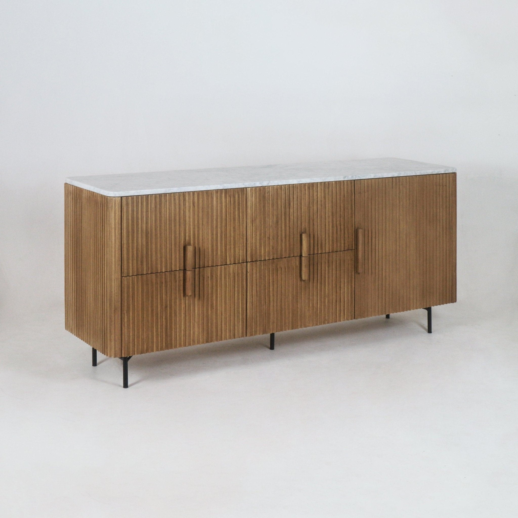 Mid-century modern teak sideboard with fluted vertical slats, white marble top, integrated wooden handles and slim black metal legs, photographed on a neutral studio background.