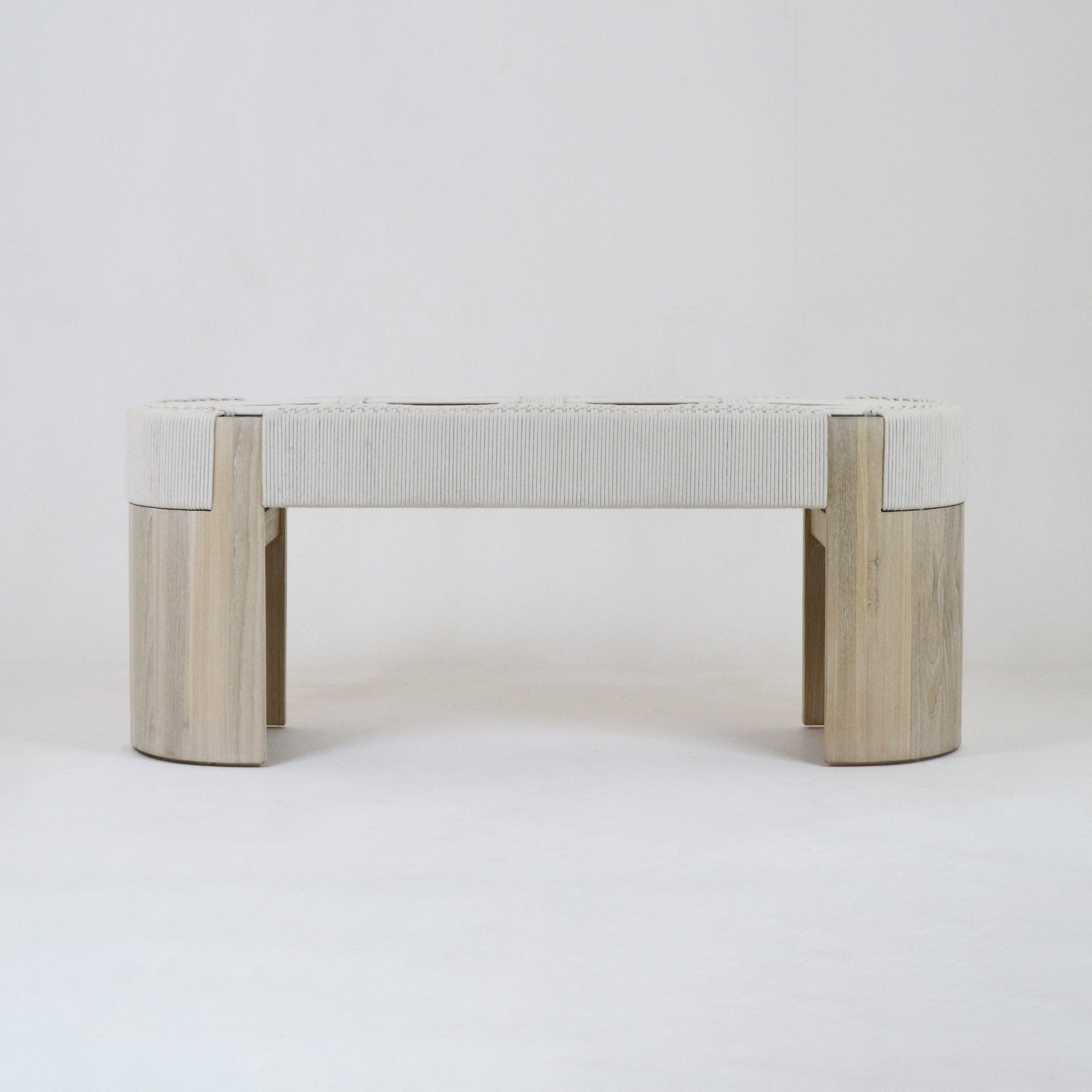 Woven off-white fabric entry bench with natural oak rounded legs and rectangular frame, modern armless design shown on a neutral background.