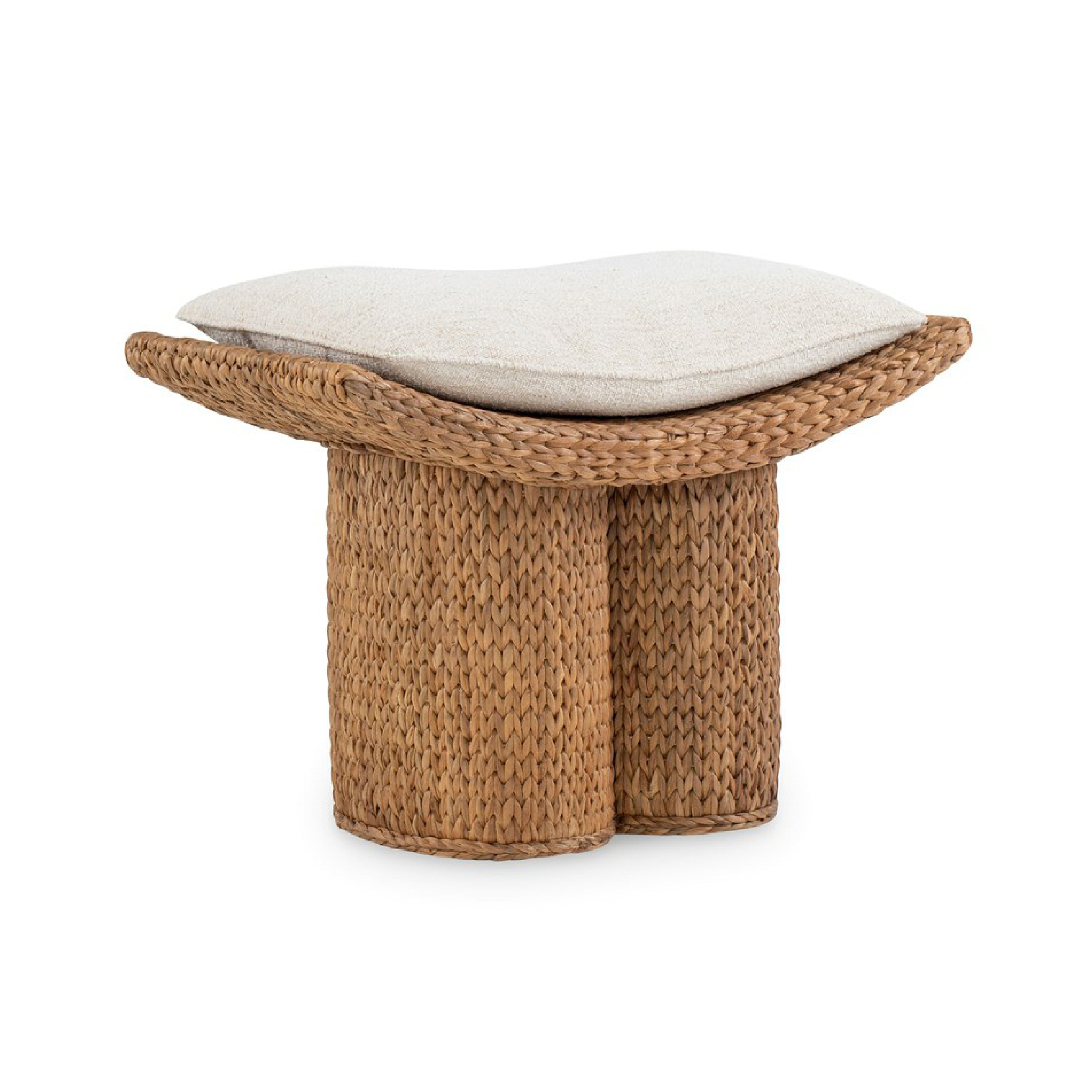 Handwoven natural water hyacinth stool with a curved braided rim and two cylindrical woven legs, topped with a removable neutral beige fabric cushion for a modern rustic accent in living or bedroom spaces.