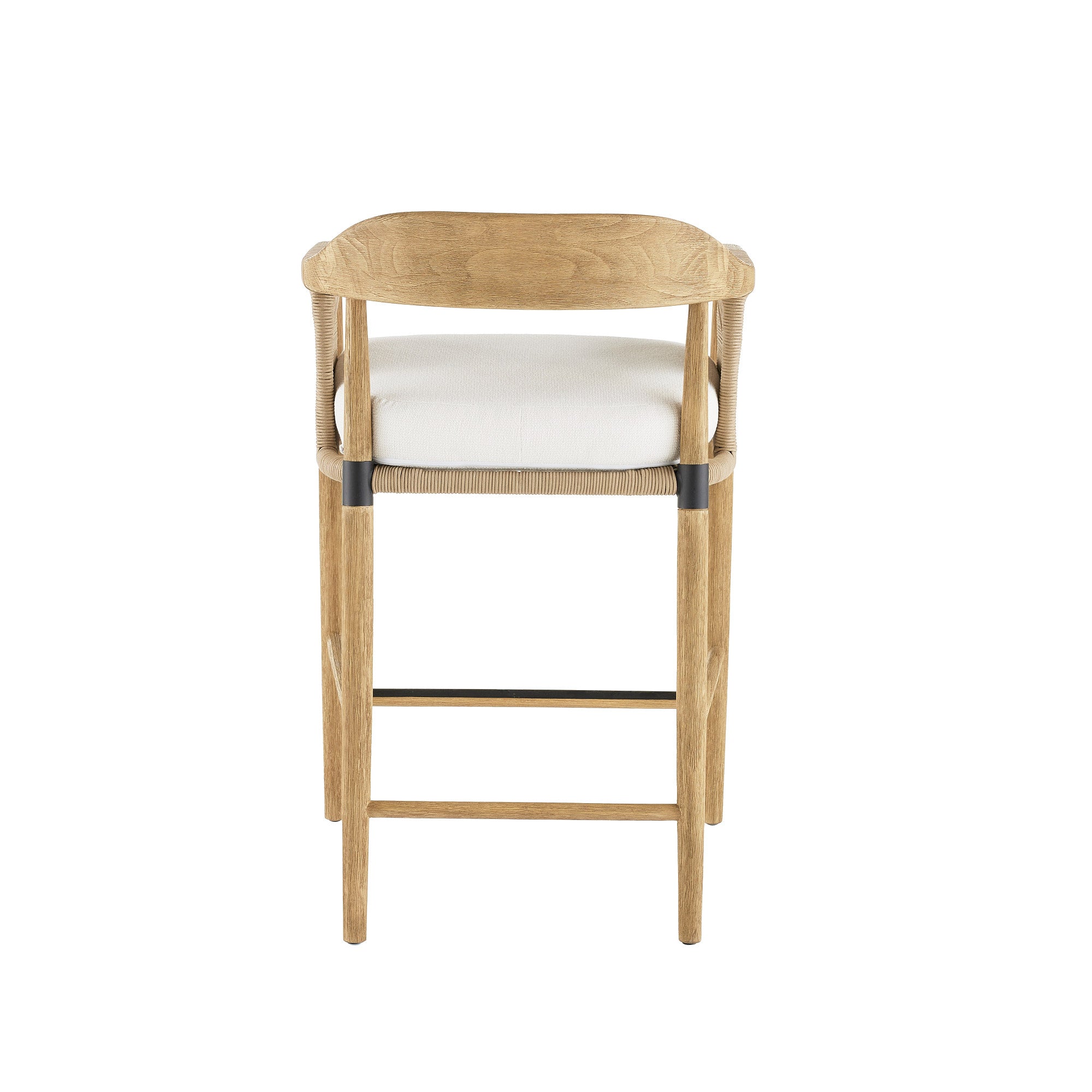 Rear view of a natural wood counter stool with a curved woven backrest, cream fabric seat cushion, rope-wrapped frame details and a black metal footrest accent.