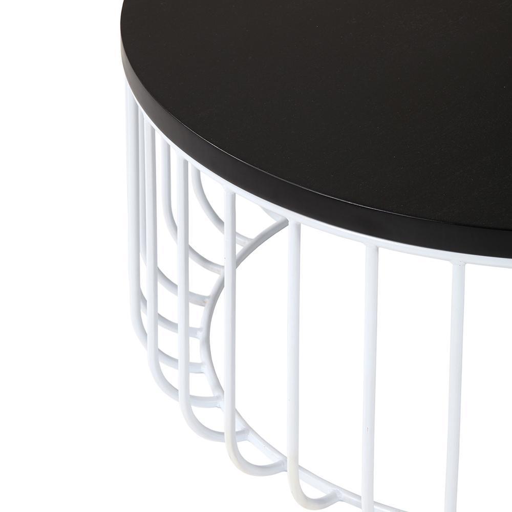 Close-up of a round mahogany-finish tabletop with a dark black surface resting on a white metal wire base, showing curved vertical steel rods and the slim table edge.