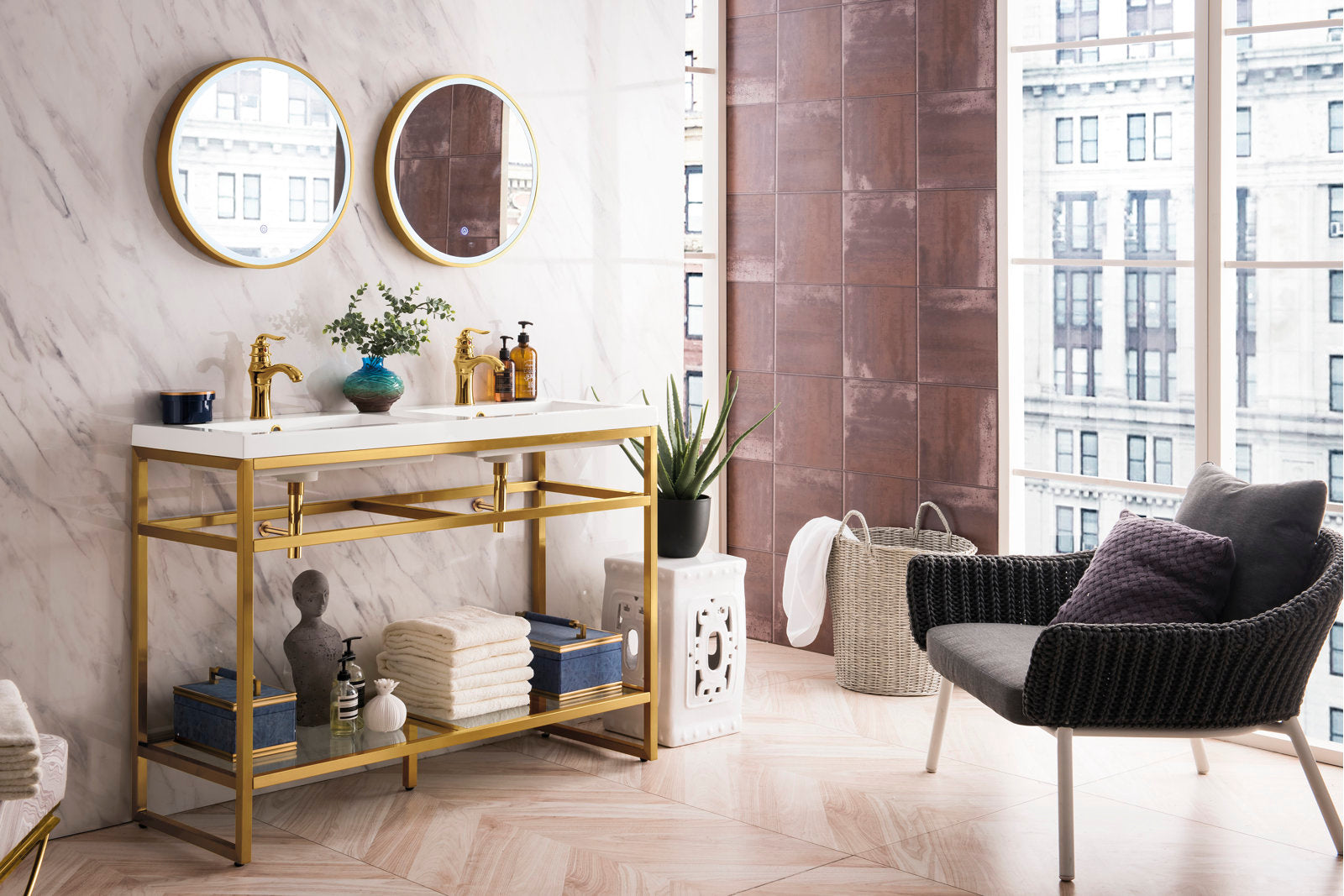 47-inch contemporary glam double sink bathroom vanity with gold metal frame and stone top, paired with two round gold-framed mirrors, gold faucets and an open lower shelf styled with folded towels and decor.