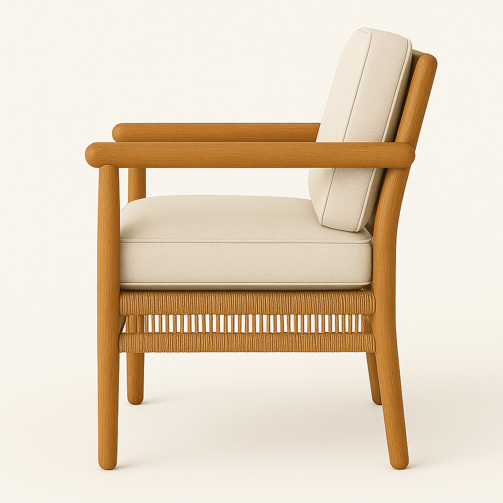 Side view of an outdoor dining chair with a natural teak wood frame, rounded armrests, woven rope detailing beneath a cream upholstered seat and matching back cushion.