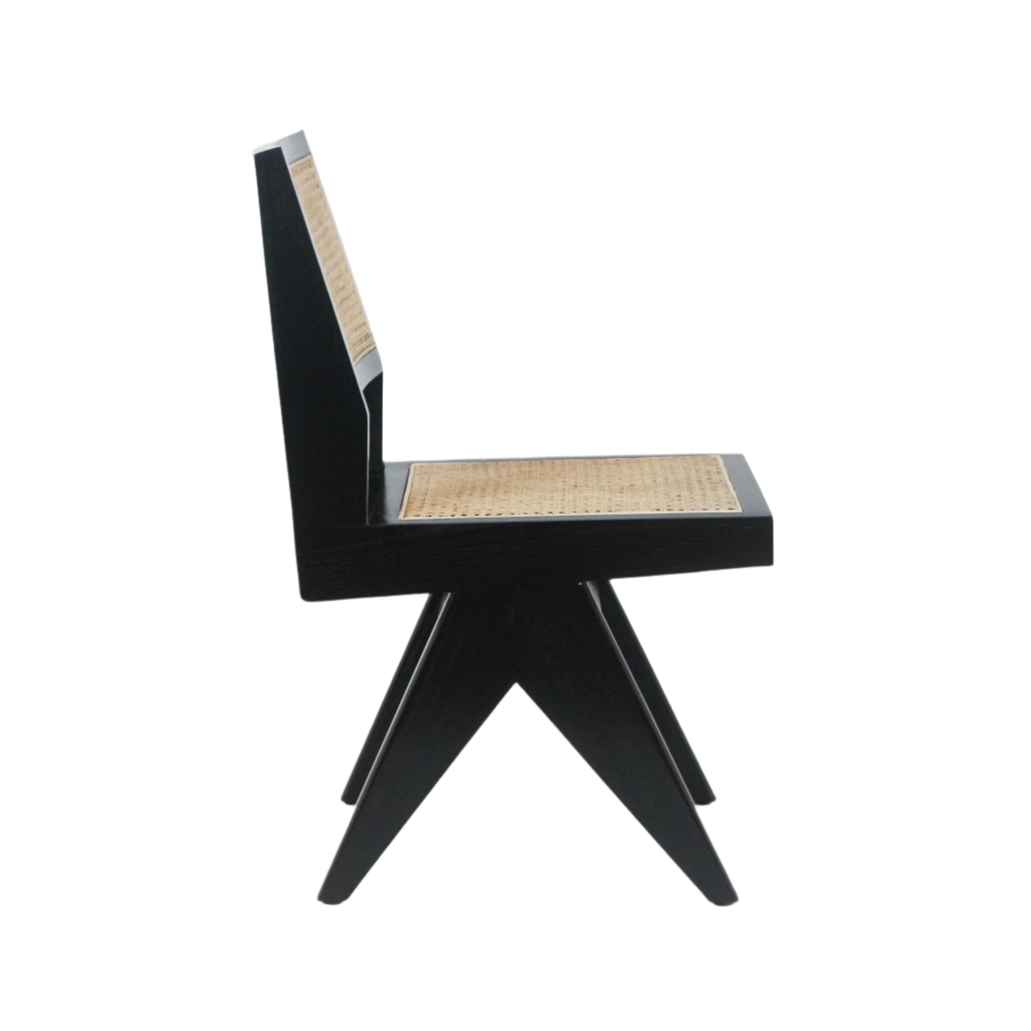 Profile view of an armless dining side chair with a black solid-wood frame and woven natural cane seat and back, modern angular silhouette with splayed X-shaped legs on a white background.