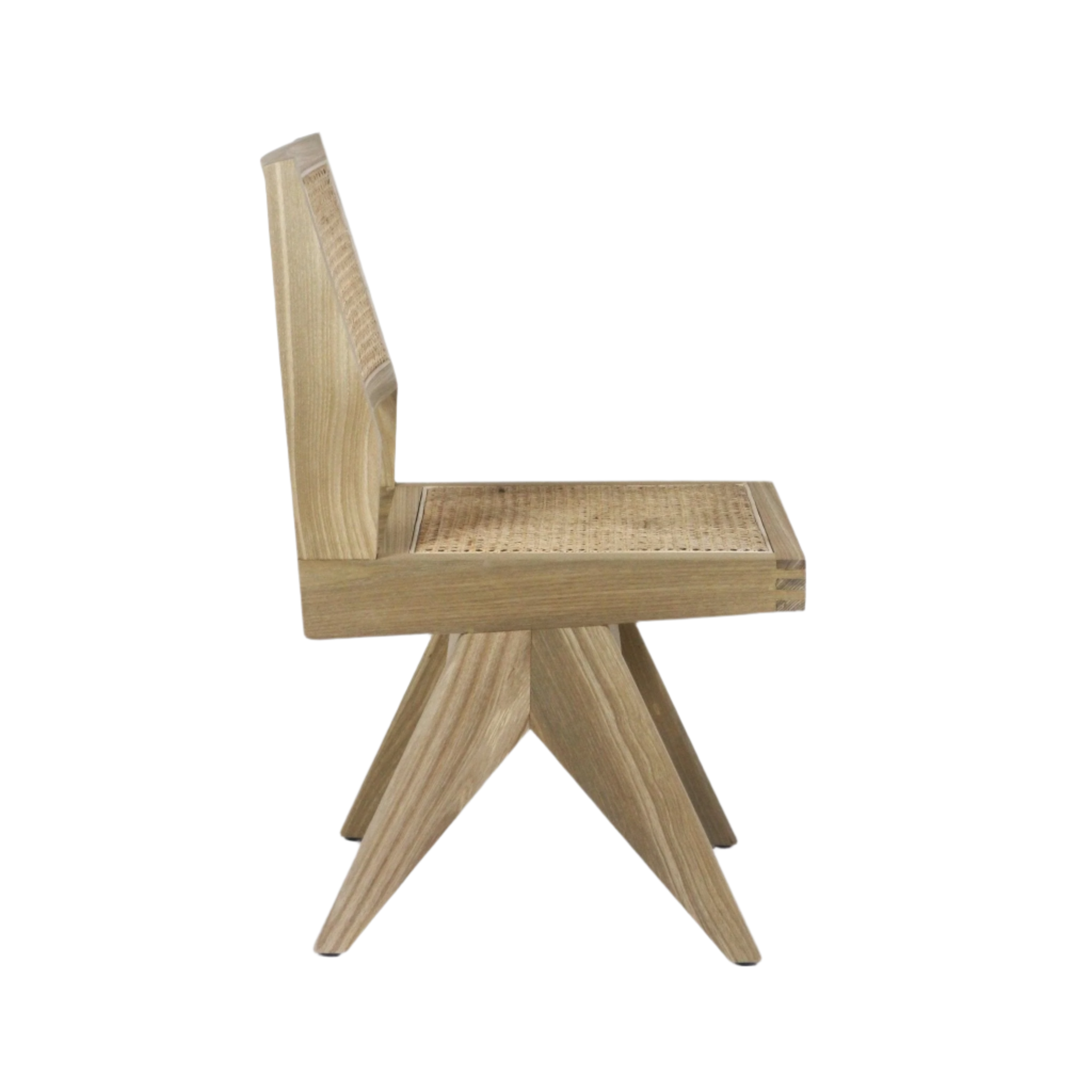 Side profile of an armless dining chair in natural blonde solid wood with woven Vienna cane seat and back, boxy seat frame and angular four-point legs against a white background.