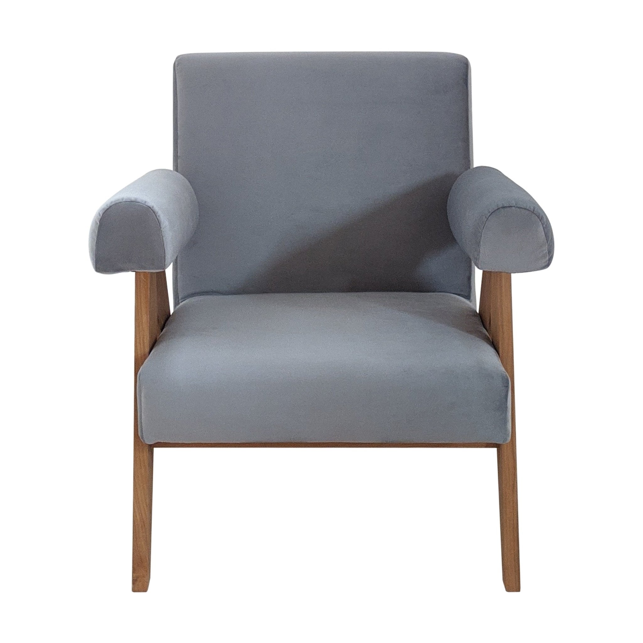 Front view of a modern accent chair with soft gray fabric upholstery, wide cushioned seat, rounded padded armrests and exposed natural wood frame with tapered legs.