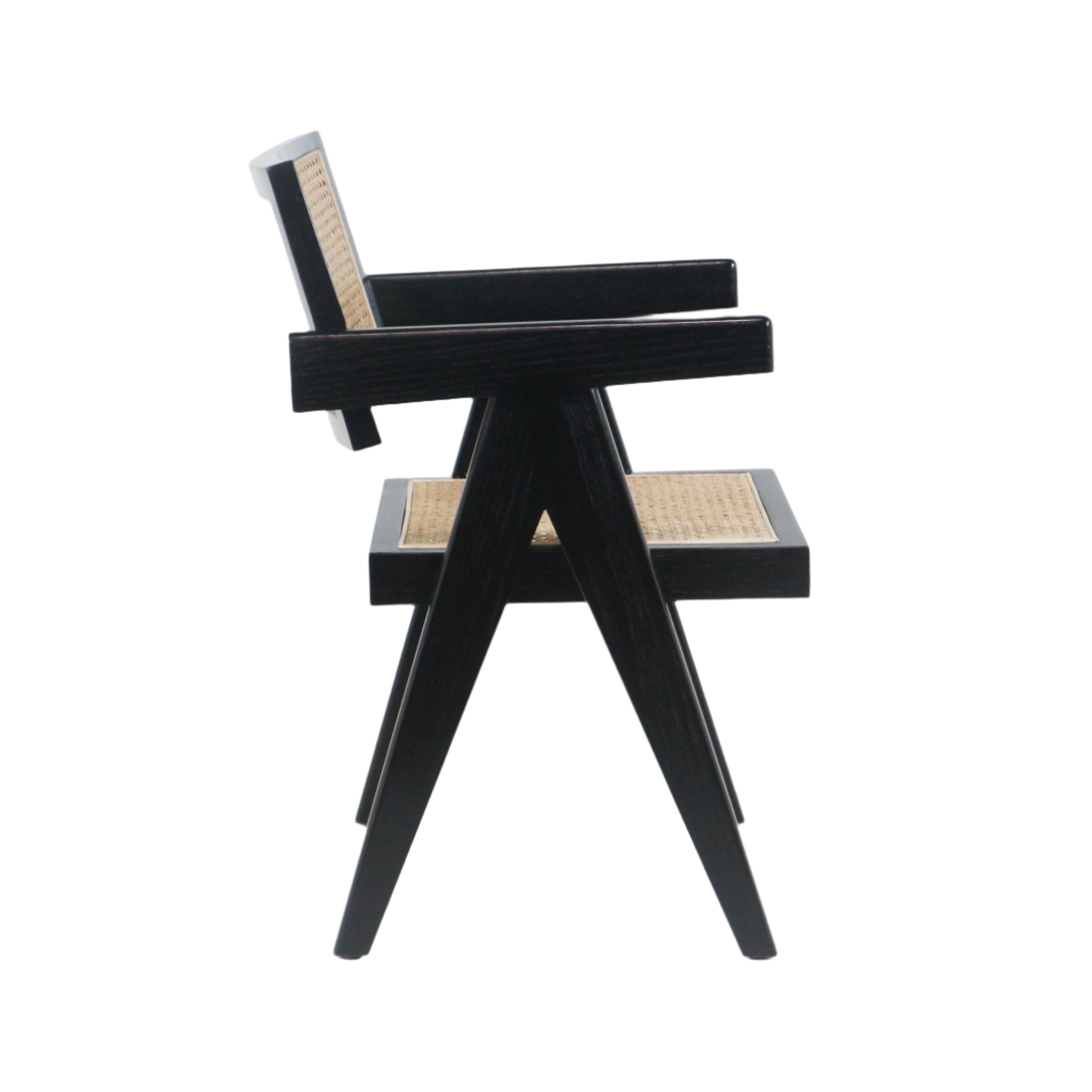 Side view of a mid-century modern black solid wood dining chair with woven cane seat and back, angular A-frame legs and straight armrests on a white background.