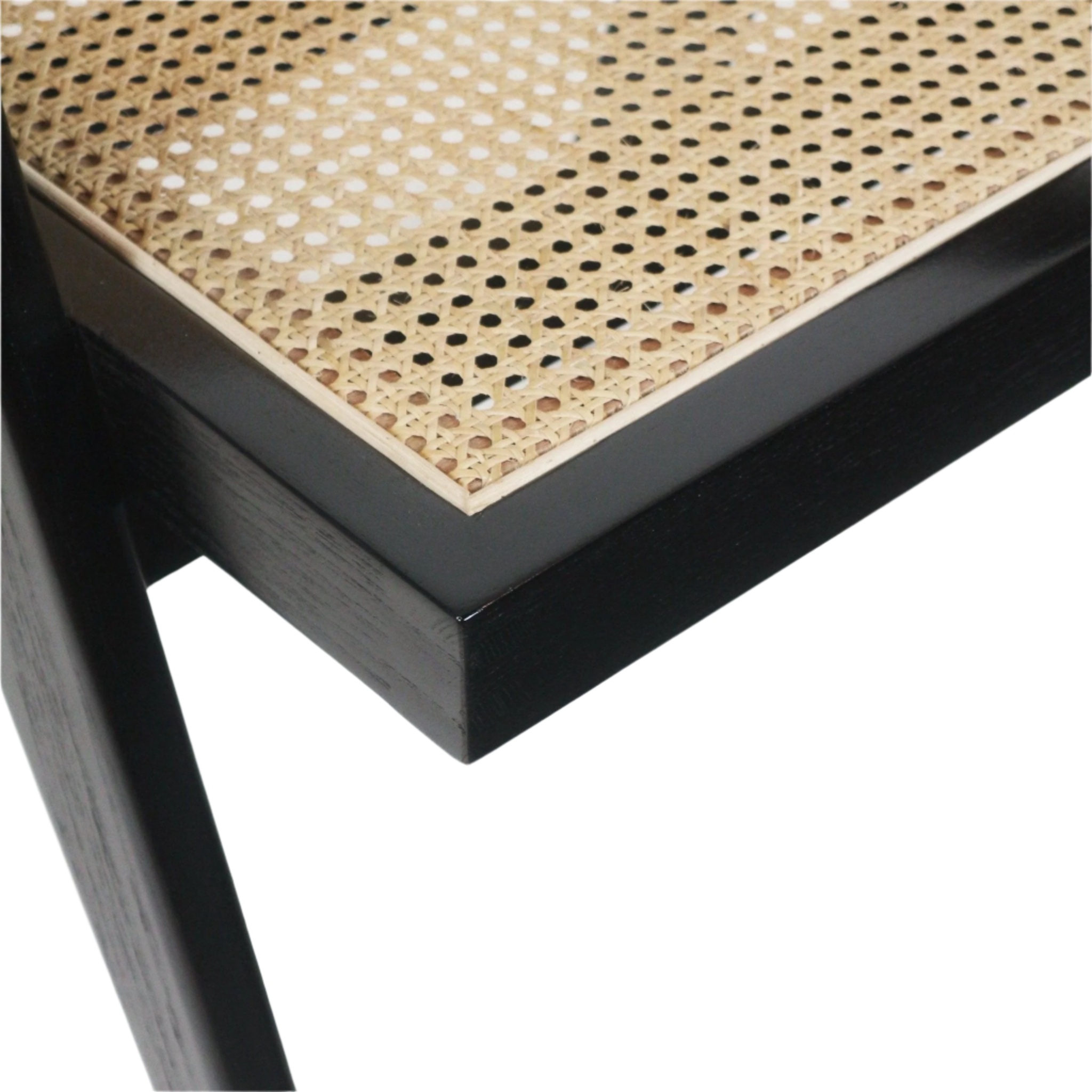 Close-up of a natural cane (Vienna weave) seat inset into a black solid wood chair frame, highlighting the woven pattern and corner joinery detail.