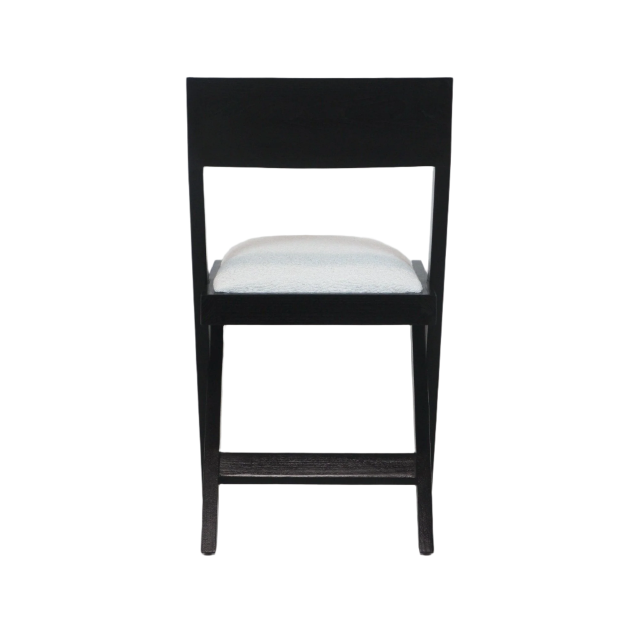 Rear view of a black wooden side chair with a rectangular low back, white boucle-upholstered seat cushion, tapered legs and a stretcher bar against a white background.