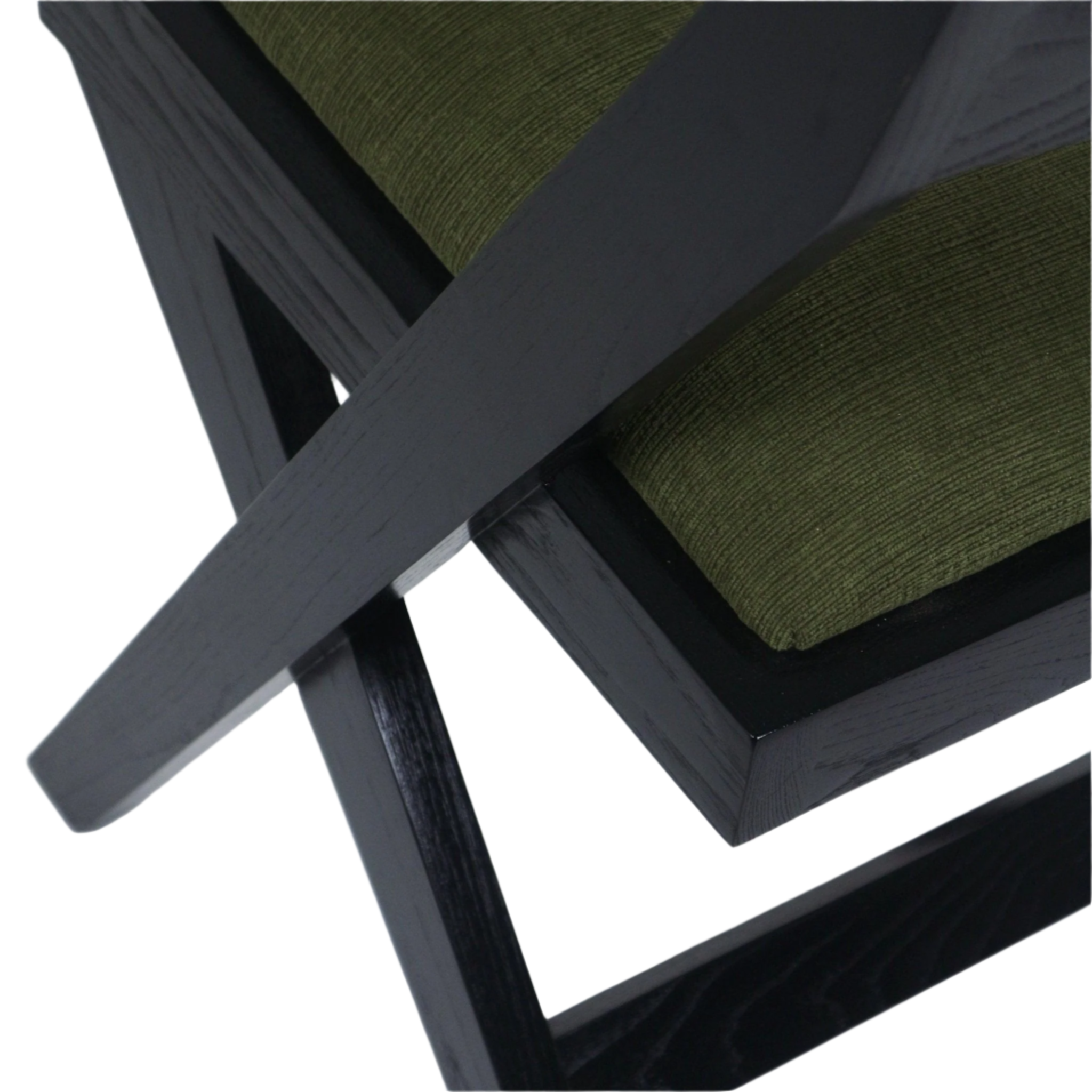 Close-up of a black semi-gloss wooden cross frame and the corner of a green chenille upholstered seat cushion, highlighting wood grain, joinery and textured fabric.