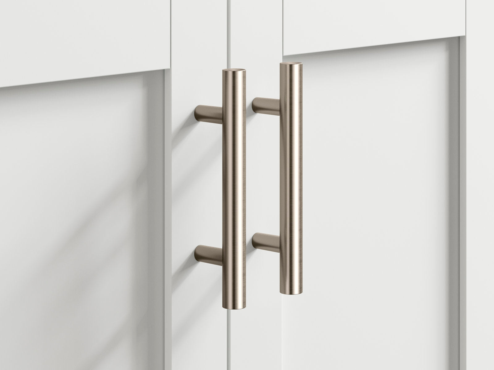 Close-up of two brushed brass-tone cylindrical bar pulls installed on stone-colored solid wood modern bathroom vanity doors, highlighting the metal finish and mounting posts.
