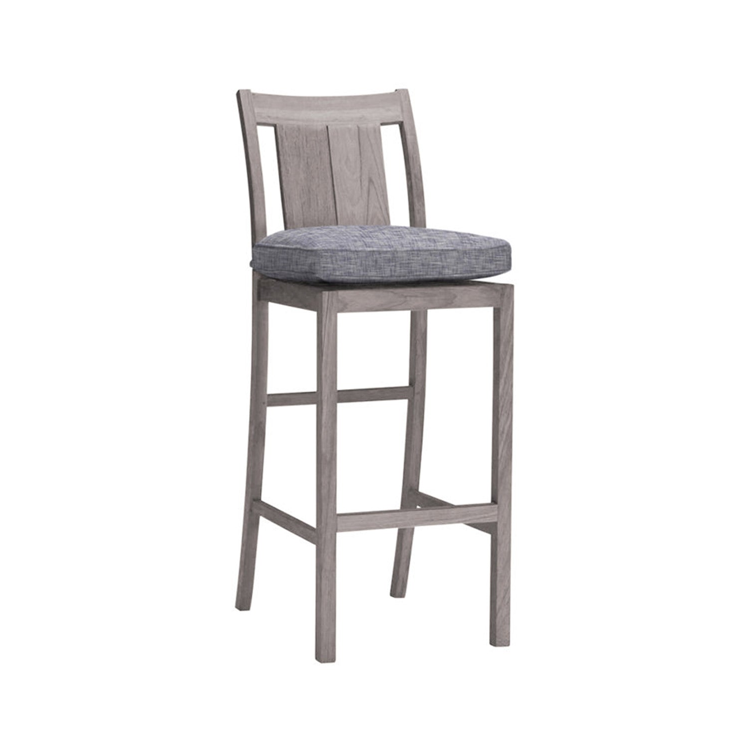 Armless teak outdoor bar stool with slatted wood back, weathered natural finish and a blue-gray upholstered seat cushion; counter-height frame with square legs and integrated footrest.
