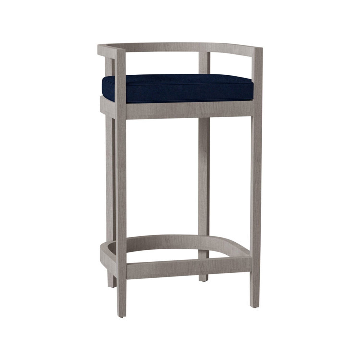 Teak outdoor bar stool with light natural finish, curved low back and arms, navy upholstered cushion seat, tall square legs and integrated curved footrest in a coastal style.