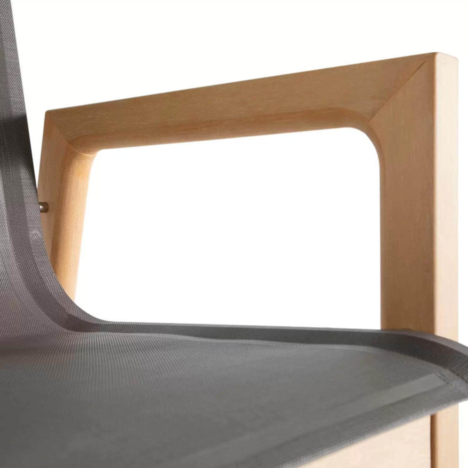 Close-up of a teak outdoor bar stool showing the natural wood square armrest and rounded corner joinery with a grey mesh seat surface.