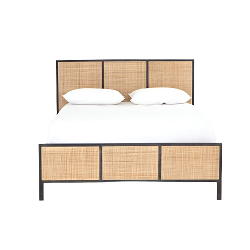 Front view of a teak and rattan boho-style platform bed with a dark wooden frame, three-panel woven rattan headboard and matching footboard, shown with white bedding and two pillows.