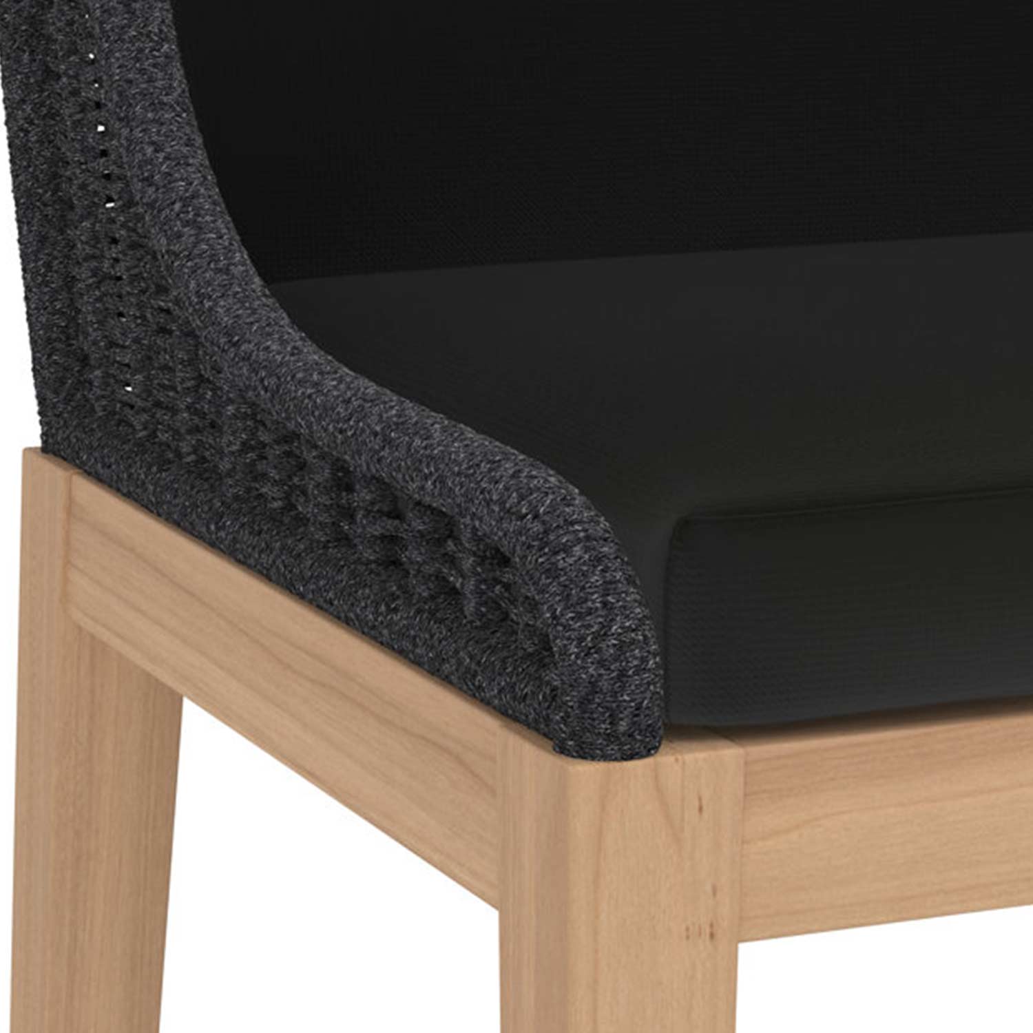 Close-up of a natural teak bar stool corner showing a light wood frame, charcoal grey woven back trim and a black outdoor upholstered seat cushion.