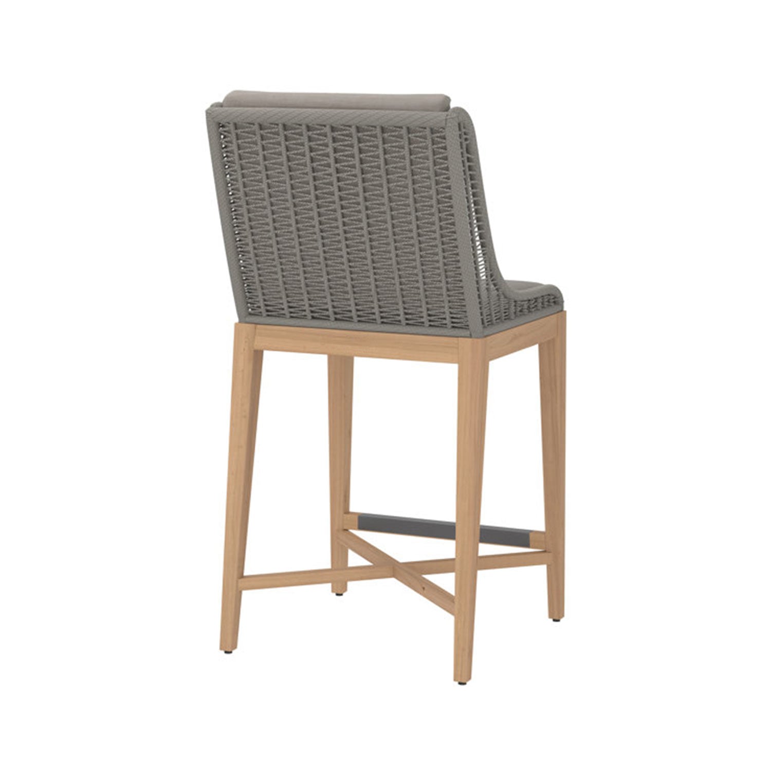 Armless outdoor bar stool with a natural teak frame, grey woven rope back and cushioned grey seat, featuring a metal footrest and cross-stretcher — coastal-inspired counter-height seating shown from the rear angle.