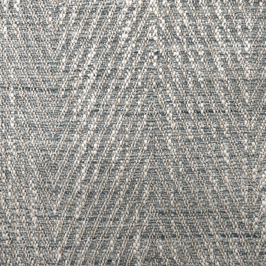 Close-up of lake herringbone upholstery fabric showing a textured chevron weave in blue-gray and cream yarns with raised boucle-like nubs.