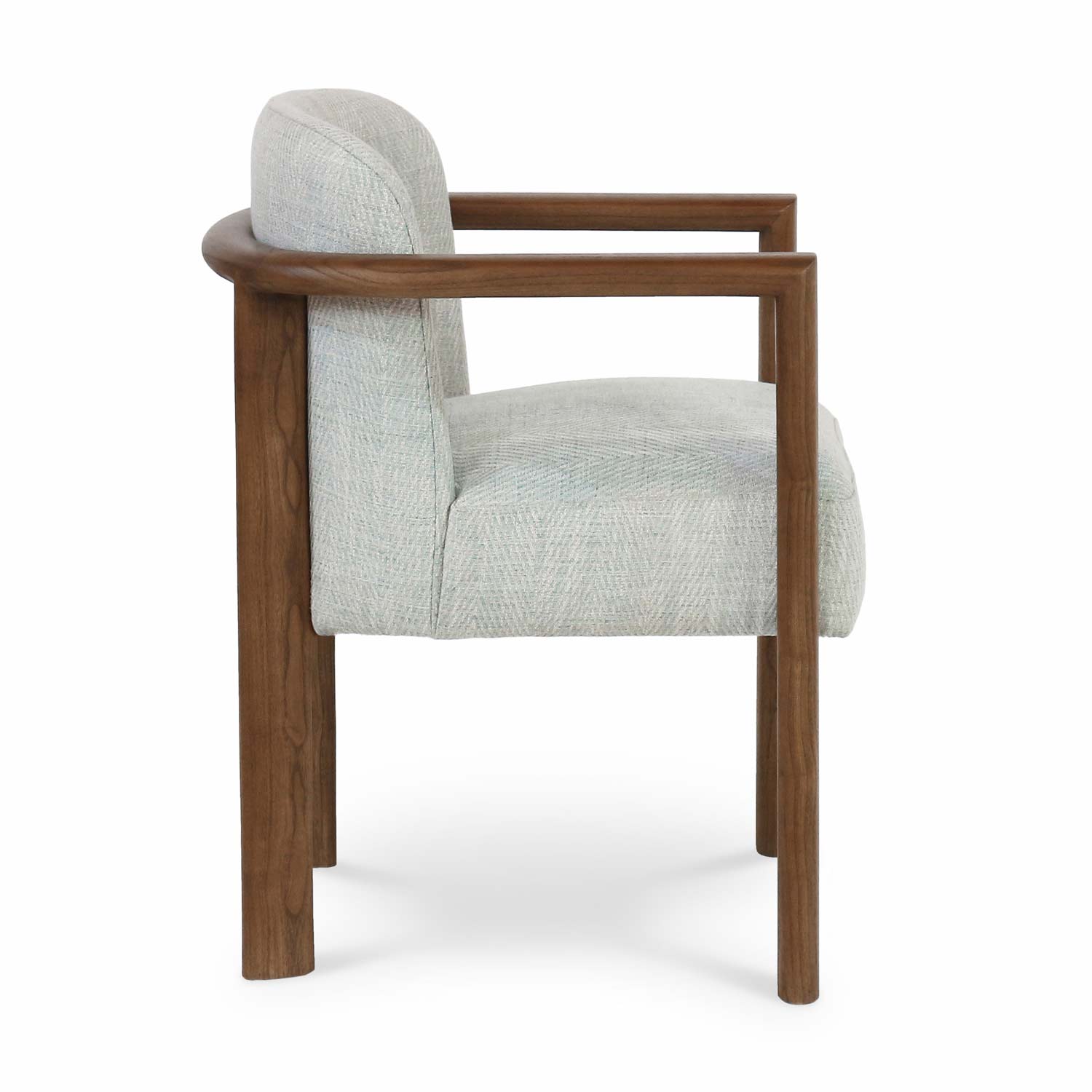 Side view of a modern dining chair with an oak wood frame and square armrests, upholstered in light gray textured fabric with a low curved back and solid wood legs.