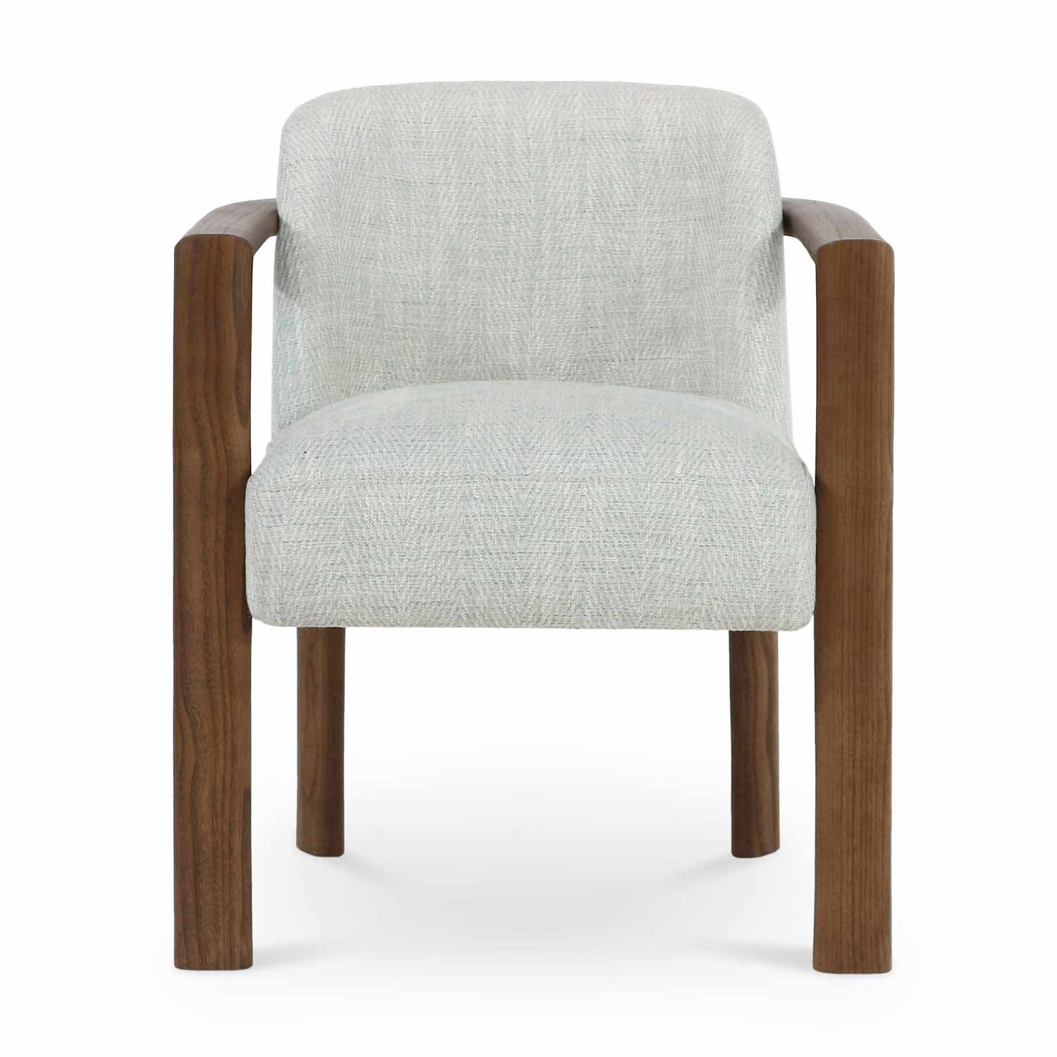Front view of a modern dining chair upholstered in light Lake Herringbone fabric with a cushioned full back, supported by a warm walnut solid wood frame with rounded arms and cylindrical legs.