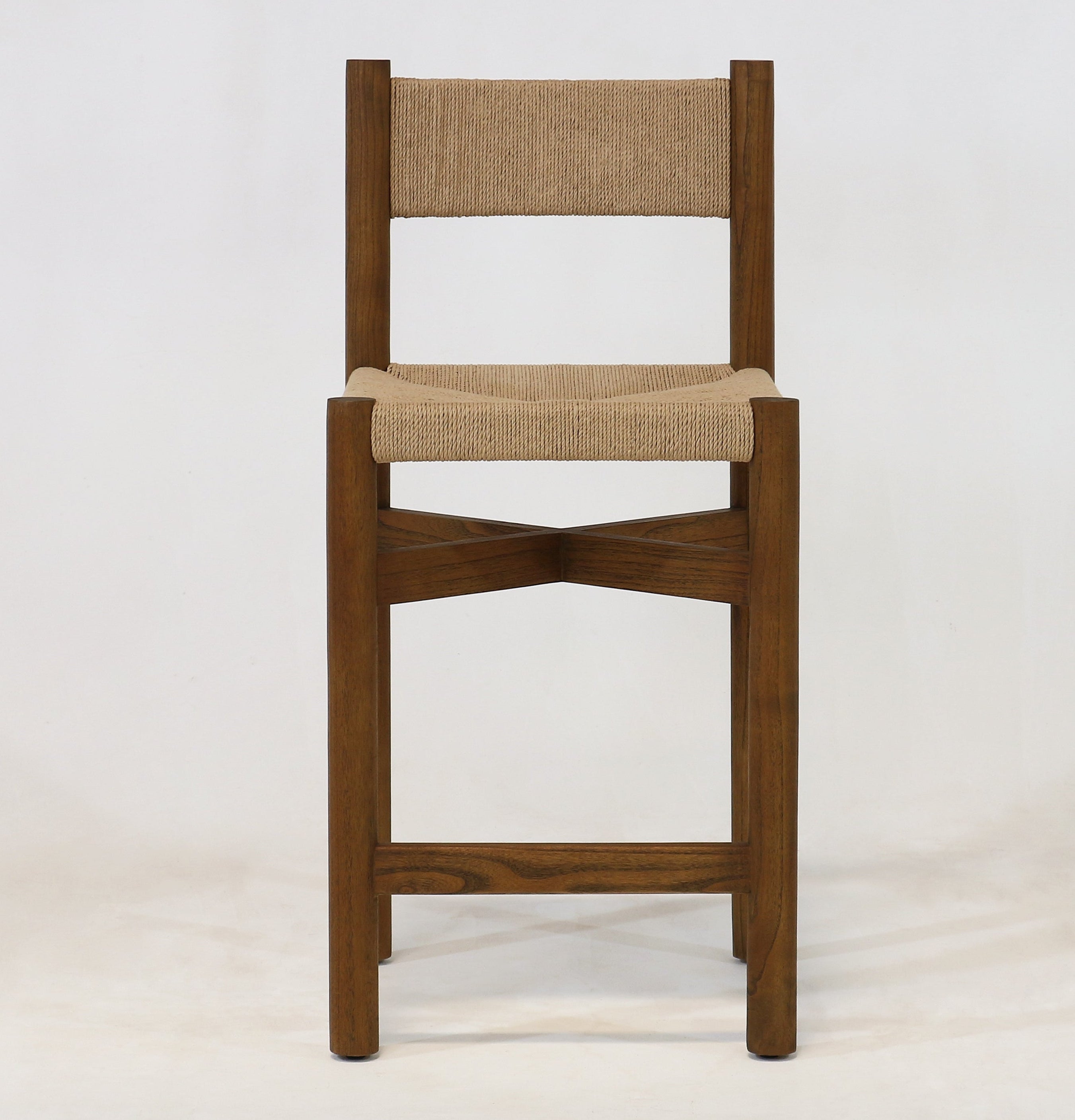 Front-facing walnut oak counter stool with woven natural papercord seat and back, armless solid wood frame with crossed stretcher detail on a plain white background.