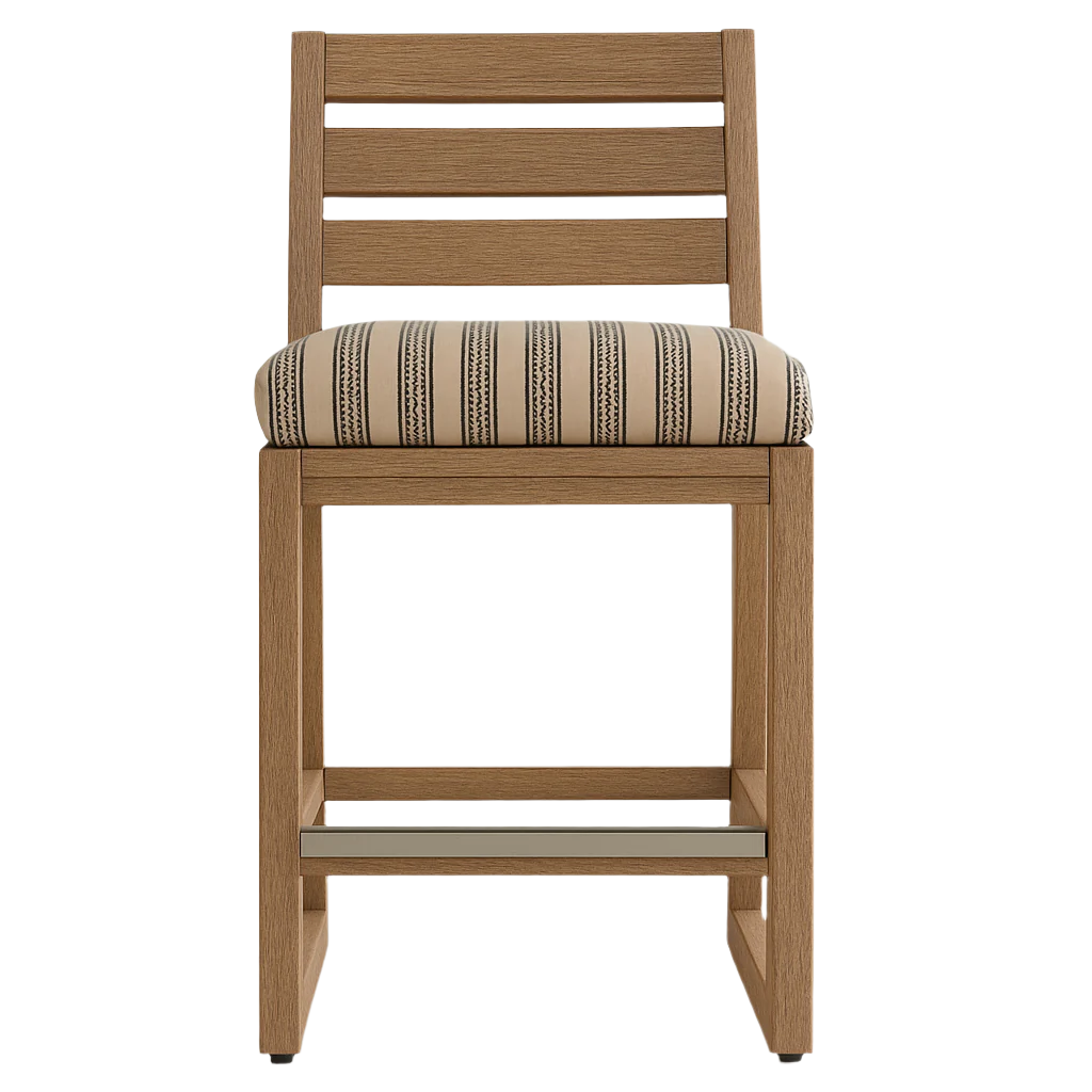 Front view of an armless teak outdoor bar stool with a slatted back, cushioned beige-and-black striped upholstery and a metal footrest.