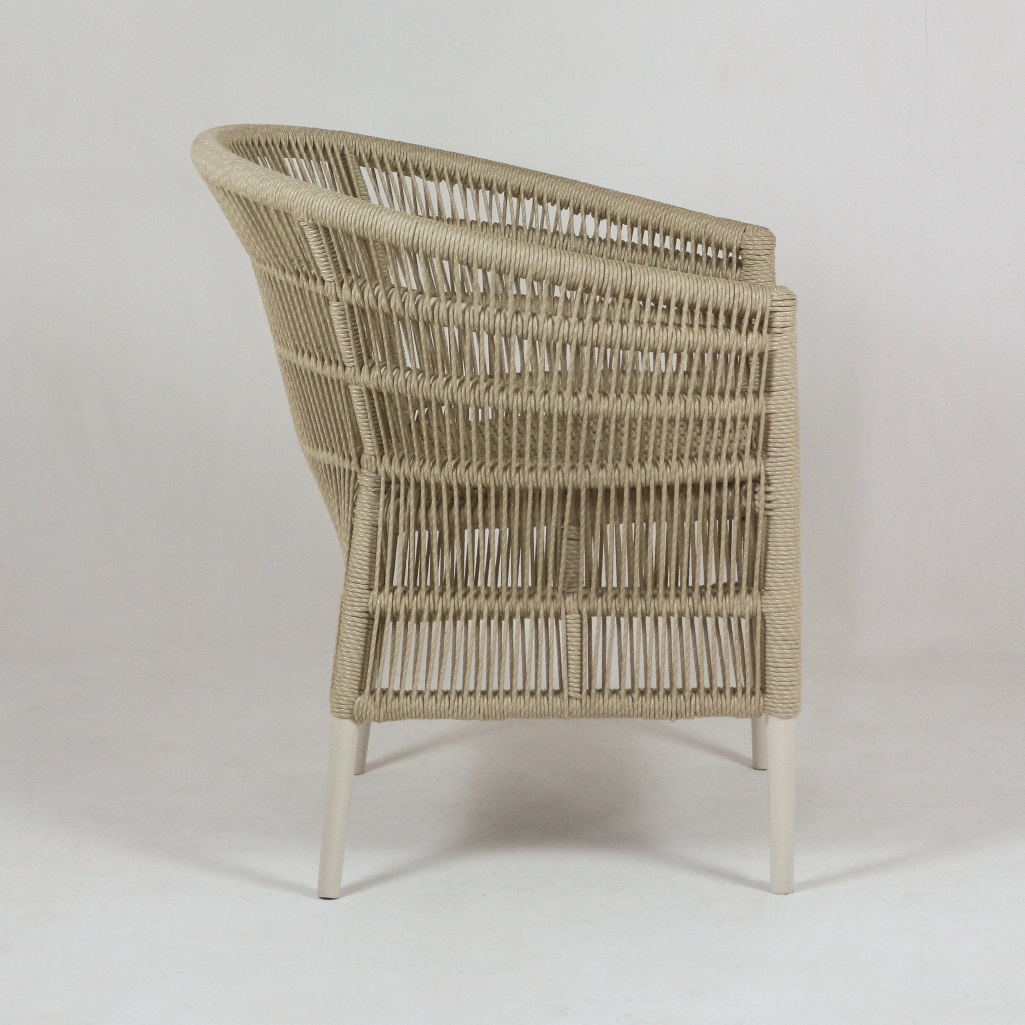 Back view of a coastal beige rope-woven patio armchair with a rounded top rail and white metal legs, shown against a plain light background.