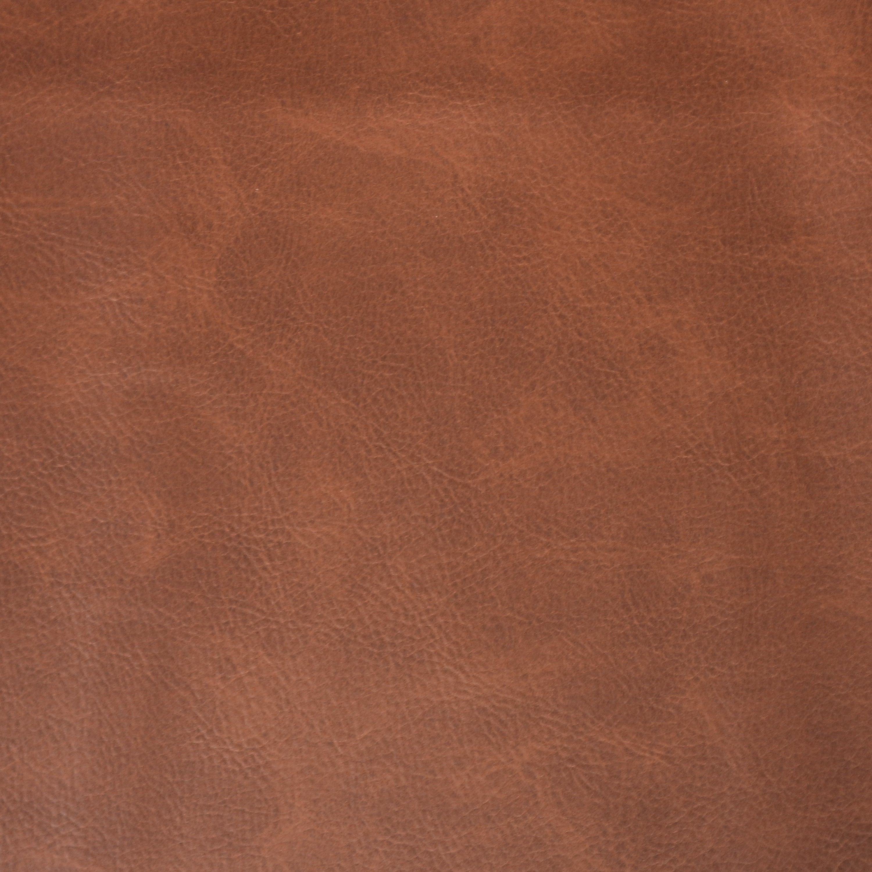 Close-up of warm teak-brown leather upholstery showing natural grain, subtle creases and a matte finish, ideal as a dining chair seat material.