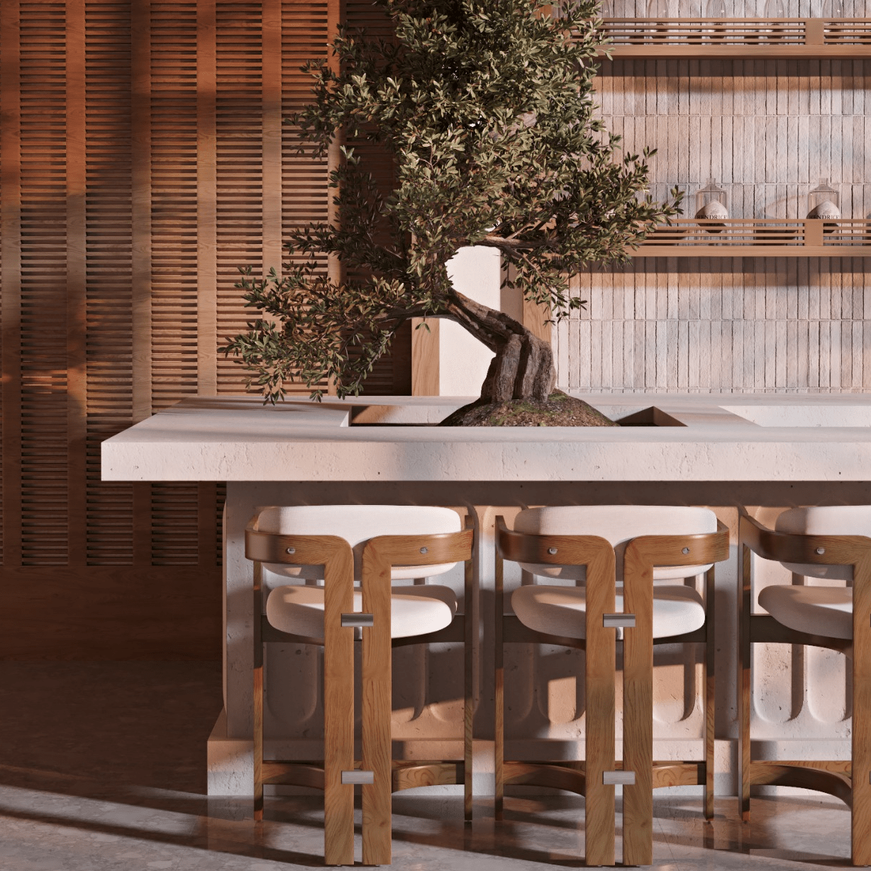 Three teak outdoor counter stools with curved wooden frames and white upholstered fabric seats tucked under a concrete island planter with a bonsai tree, set against a slatted wood wall and minimalist shelving.