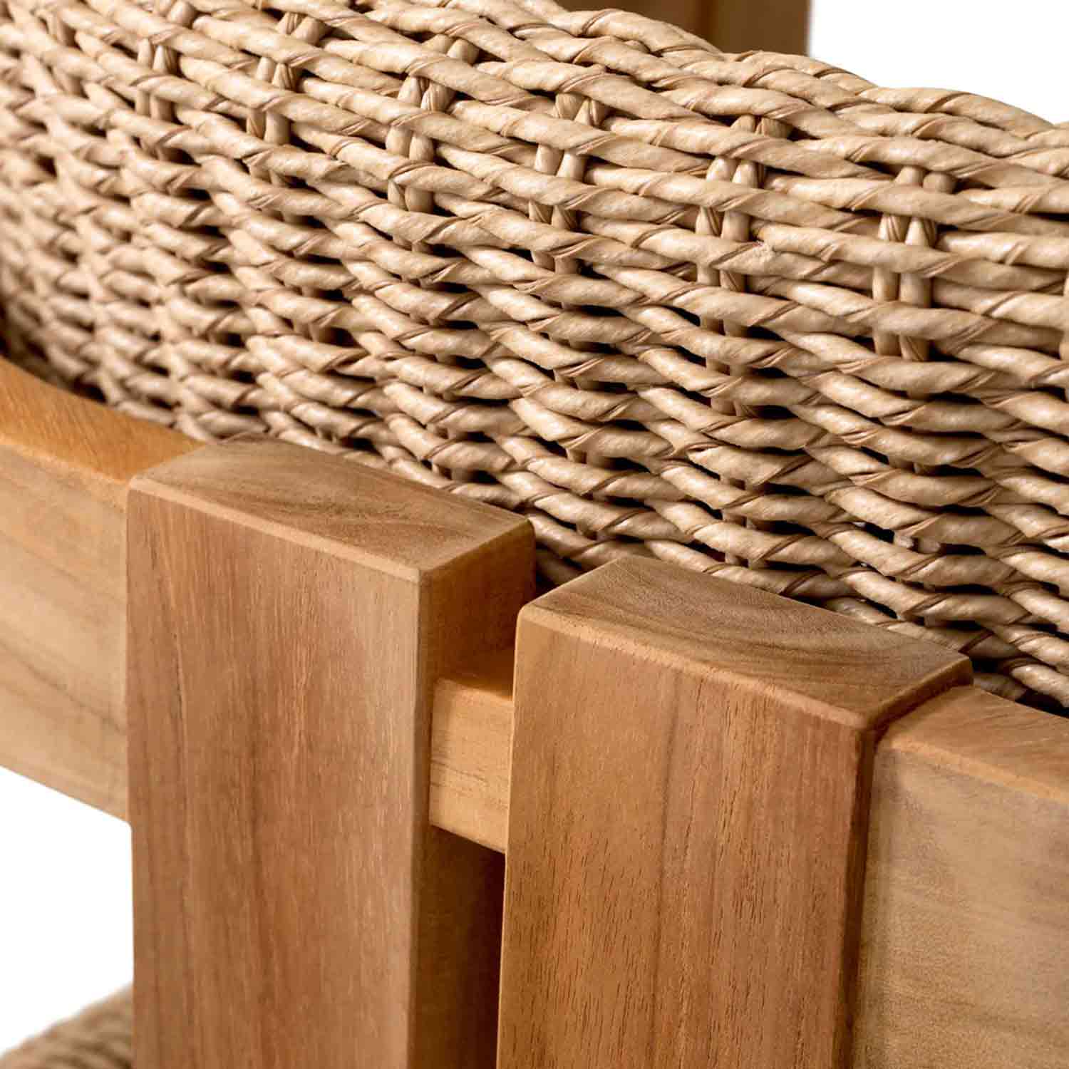 Close-up of a natural teak outdoor dining chair showing smooth teak frame and tight beige synthetic-fiber seat and back weaving with visible joinery detail.