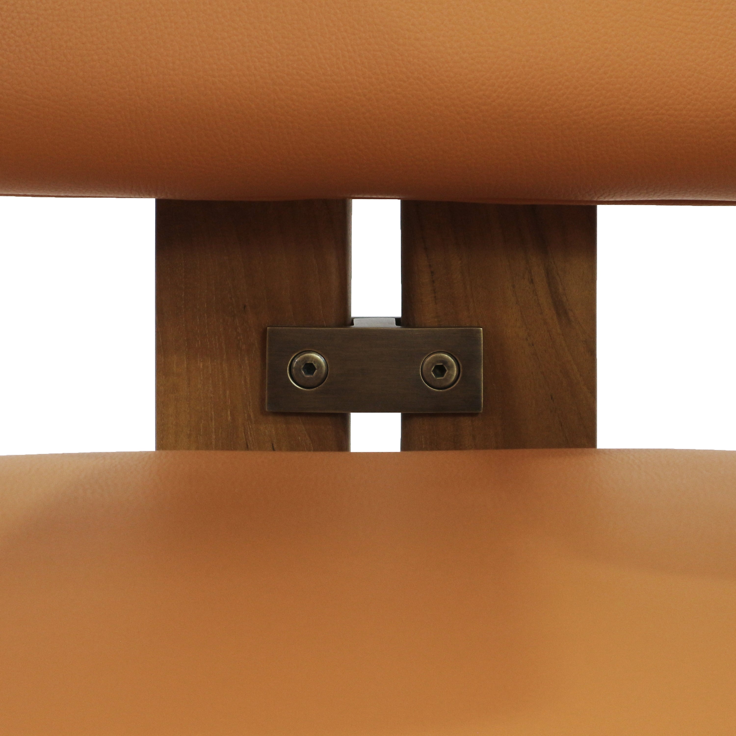 Close-up of tan nubuck leather seat and back showing walnut wood slats and an antique-brass connector plate secured by two hex screws.