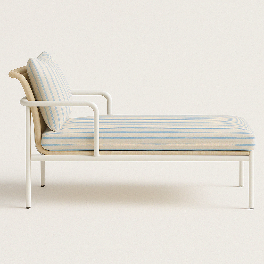 Side view of a coastal chaise lounge with a white aluminum frame, beige rattan back, and light blue-and-beige striped fabric cushion and matching pillow on a neutral background.