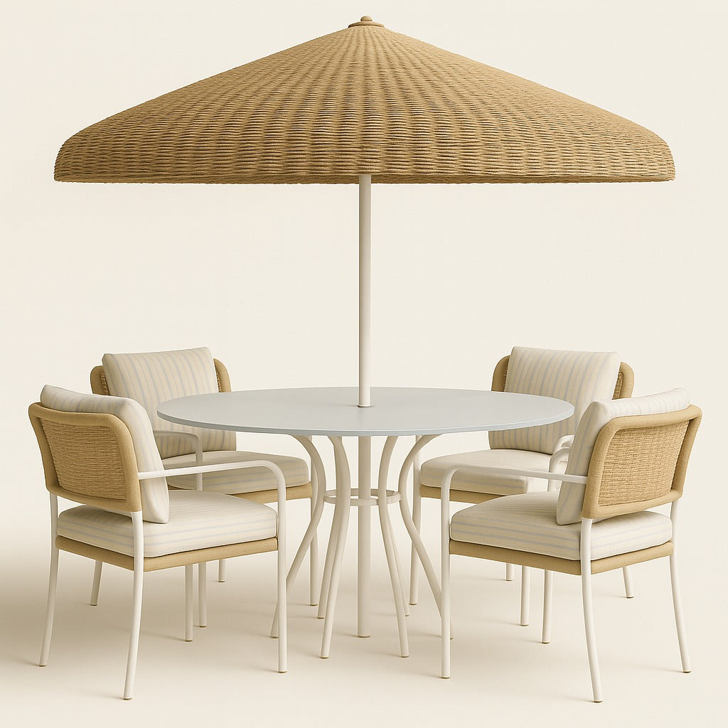Modern outdoor patio dining set featuring a round white aluminum table with central umbrella pole, four beige wicker-framed cushioned armchairs with striped cushions, and a large natural woven umbrella canopy.