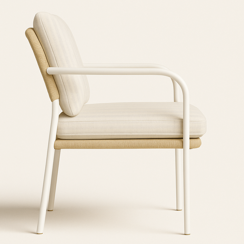 Side view of a modern outdoor dining armchair with a white powder-coated aluminum frame, curved armrests, beige upholstered seat and back cushions, and natural woven wicker trim along the back and seat edge.