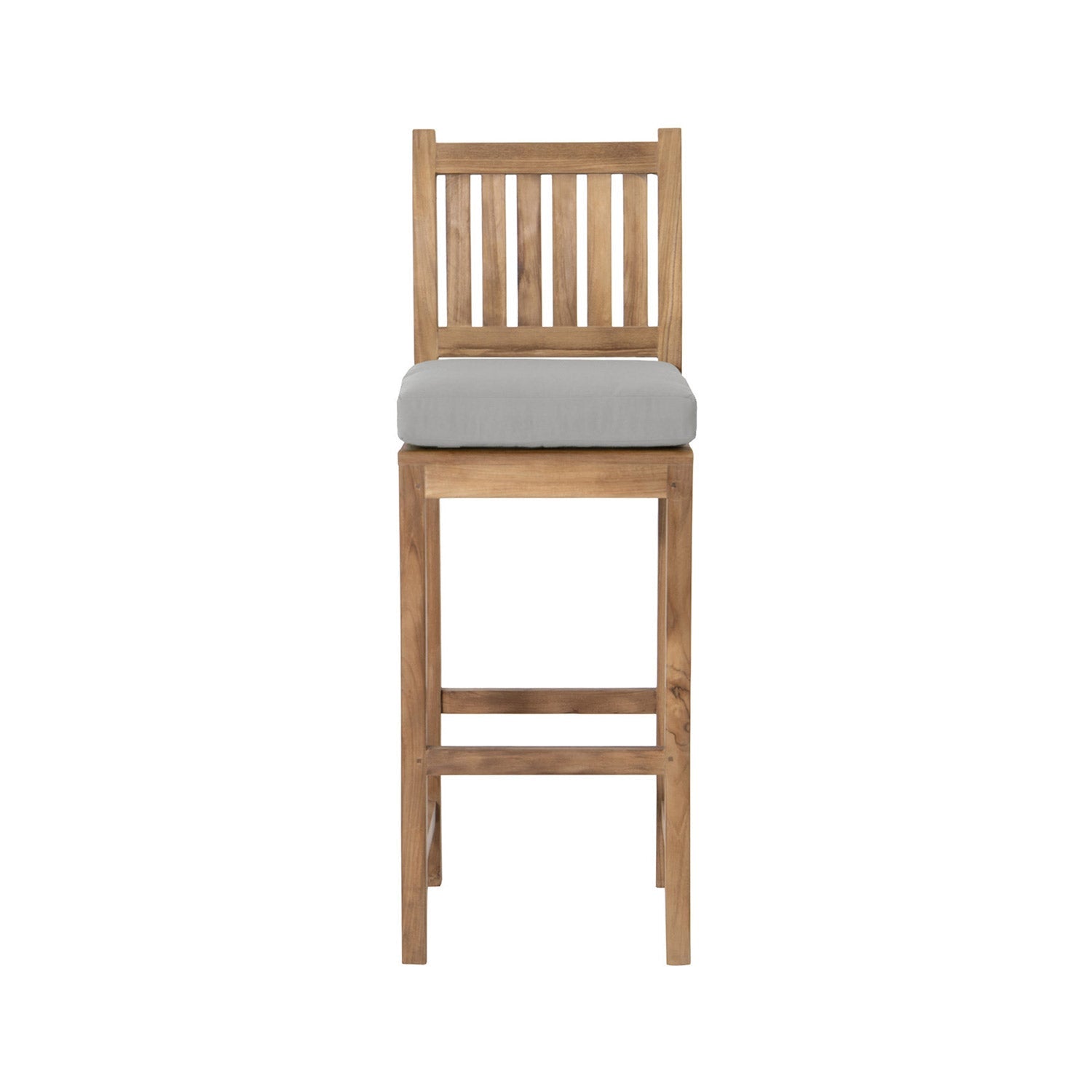 Front view of an armless teak outdoor bar stool in a natural finish, with a vertical slatted back, light gray upholstered seat cushion and tall square legs featuring a built-in footrest.