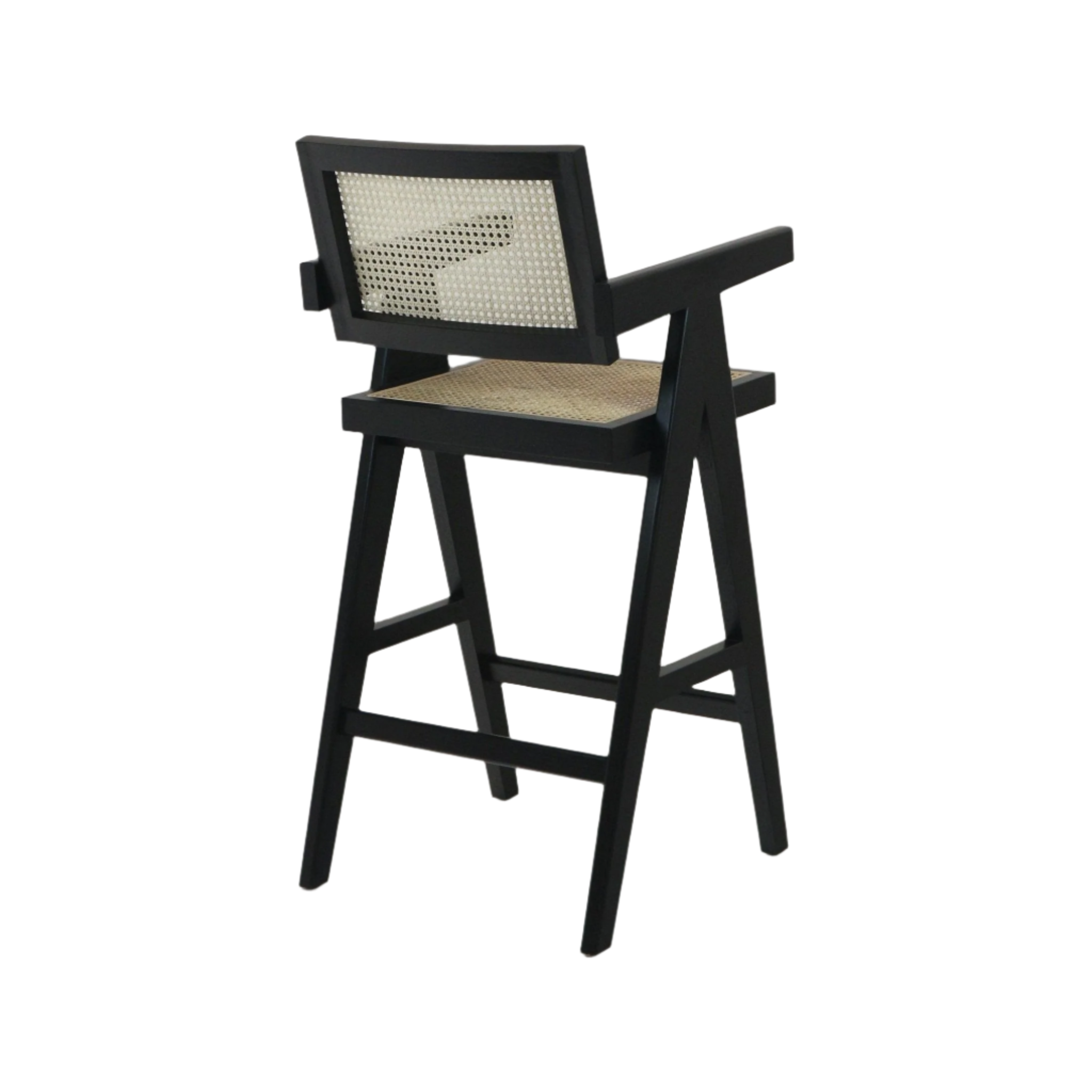 Rear three-quarter view of a black wooden bar stool with natural cane rattan seat and backrest, angled legs and short armrests in a mid-century modern silhouette.