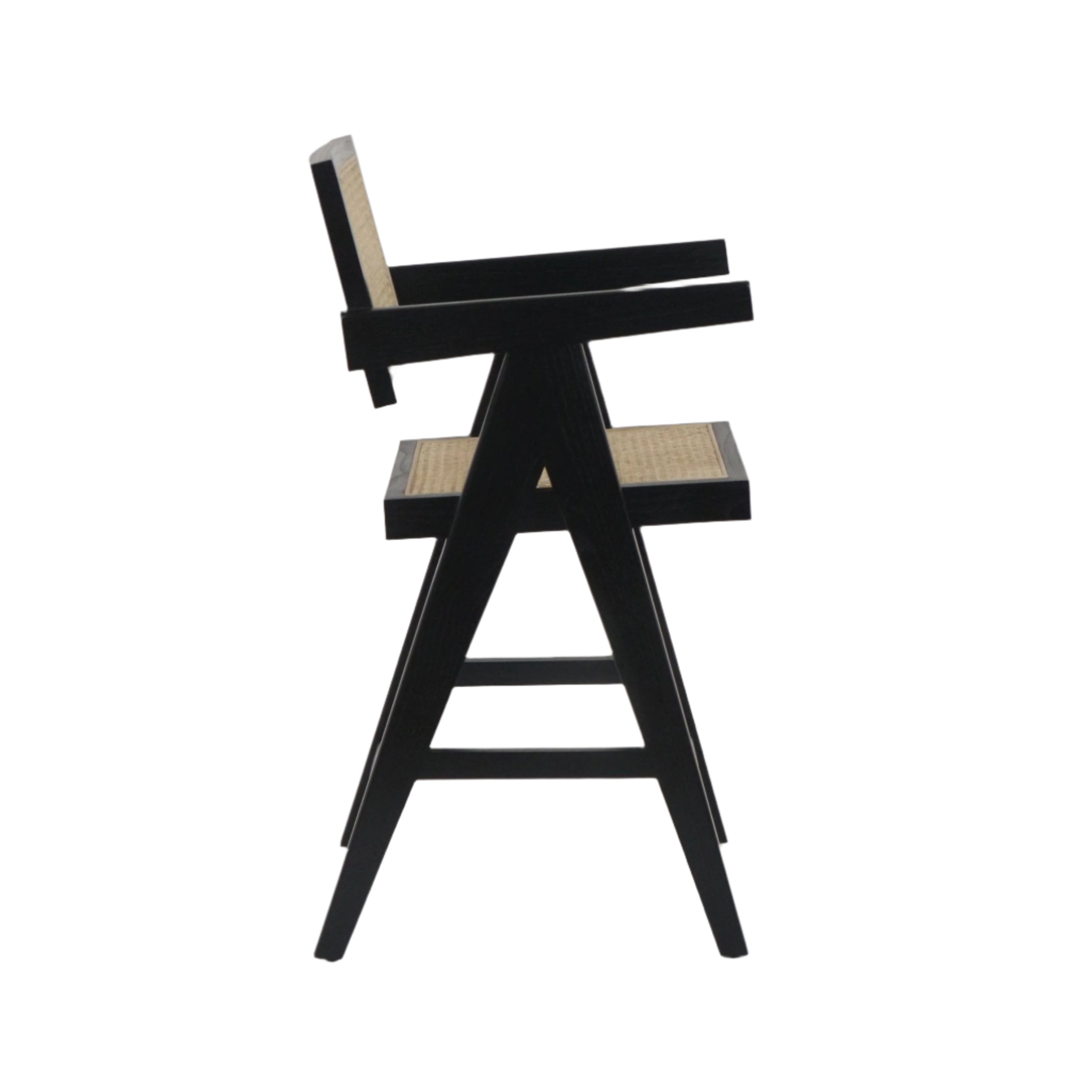 Side view of a mid-century modern counter stool with black wooden A-frame legs, natural rattan cane seat and back, and angular black armrests.