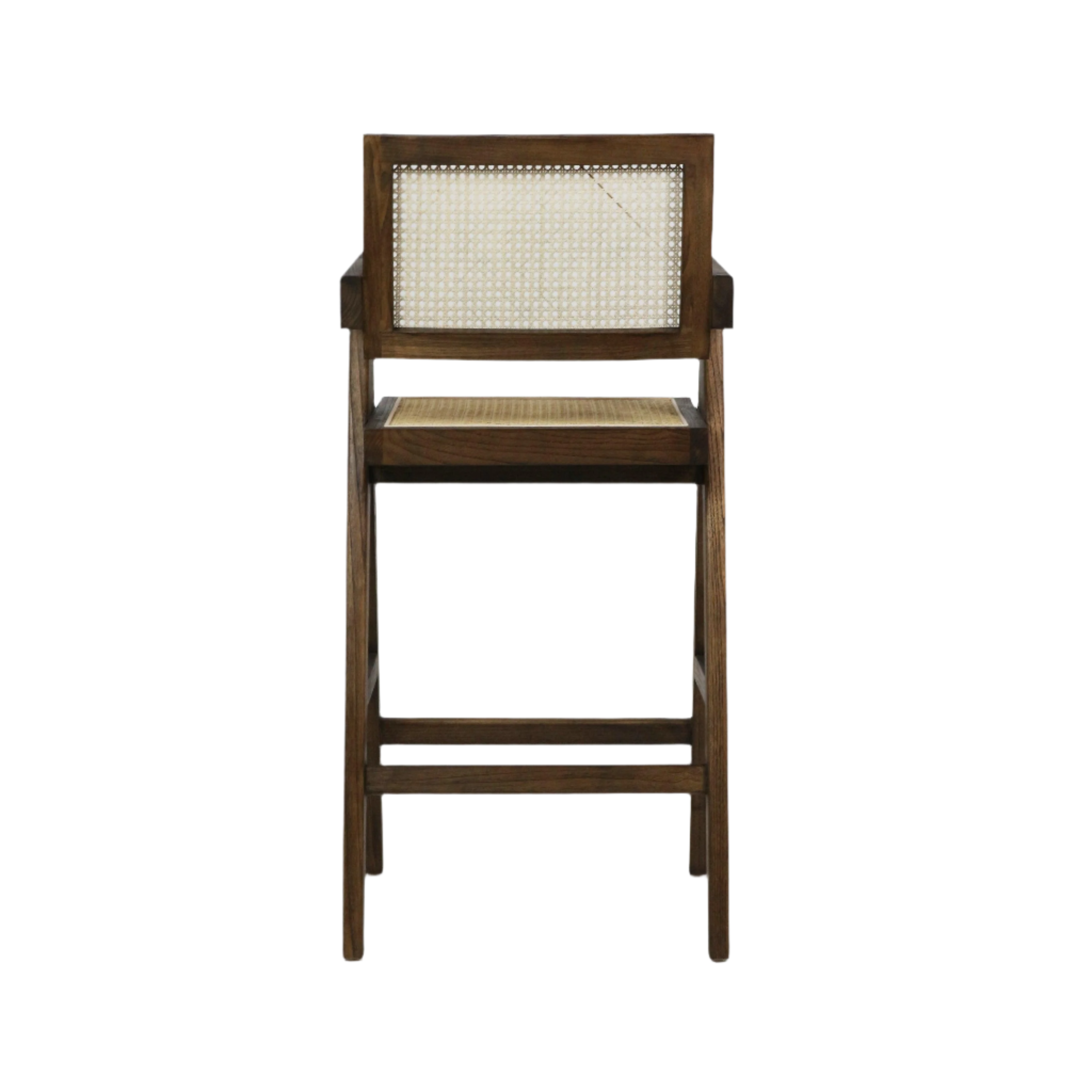 Back view of a natural medium-brown wood bar stool with a woven rattan cane back and seat, slender mid-century modern frame, short armrests and a horizontal footrest.