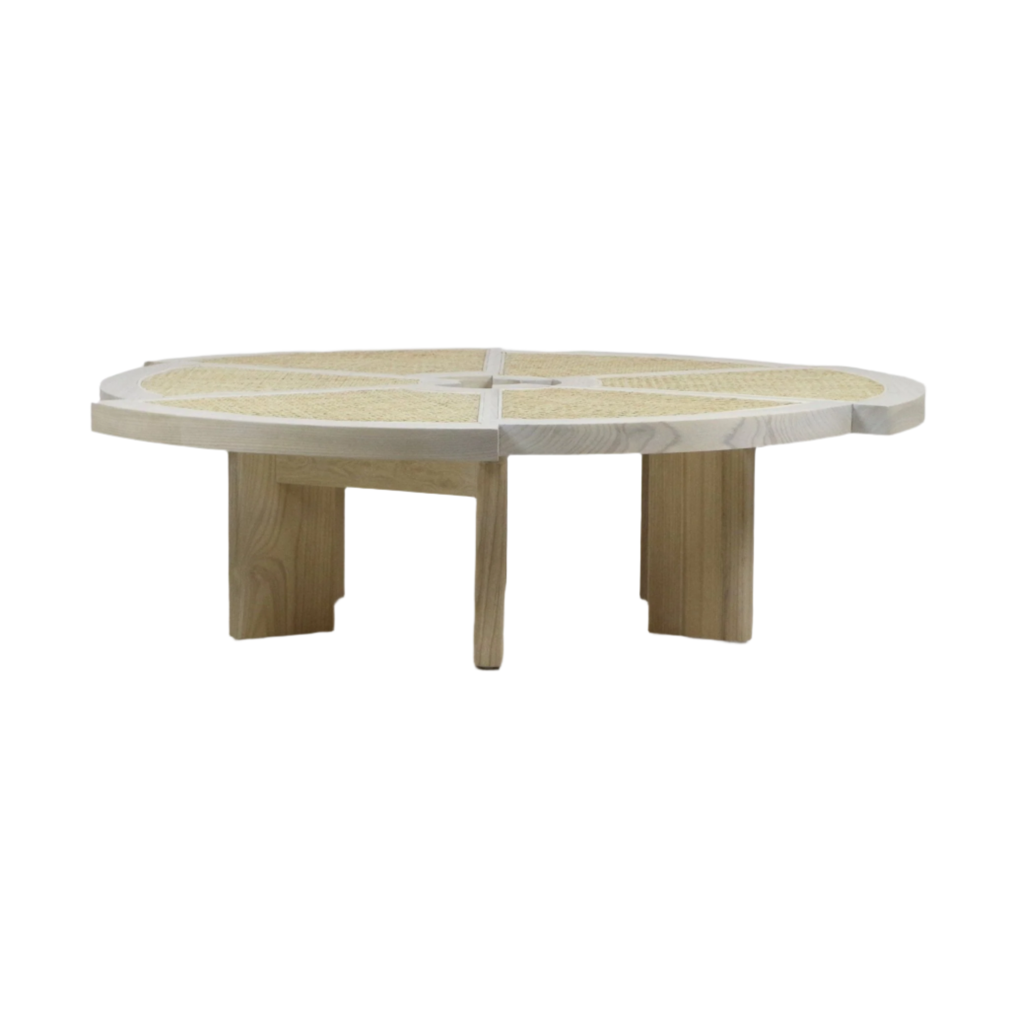 Low-profile round coffee table with a natural solid wood frame and woven cane insets in radial segments, light blonde finish and broad wooden legs for a modern, contemporary living room look.
